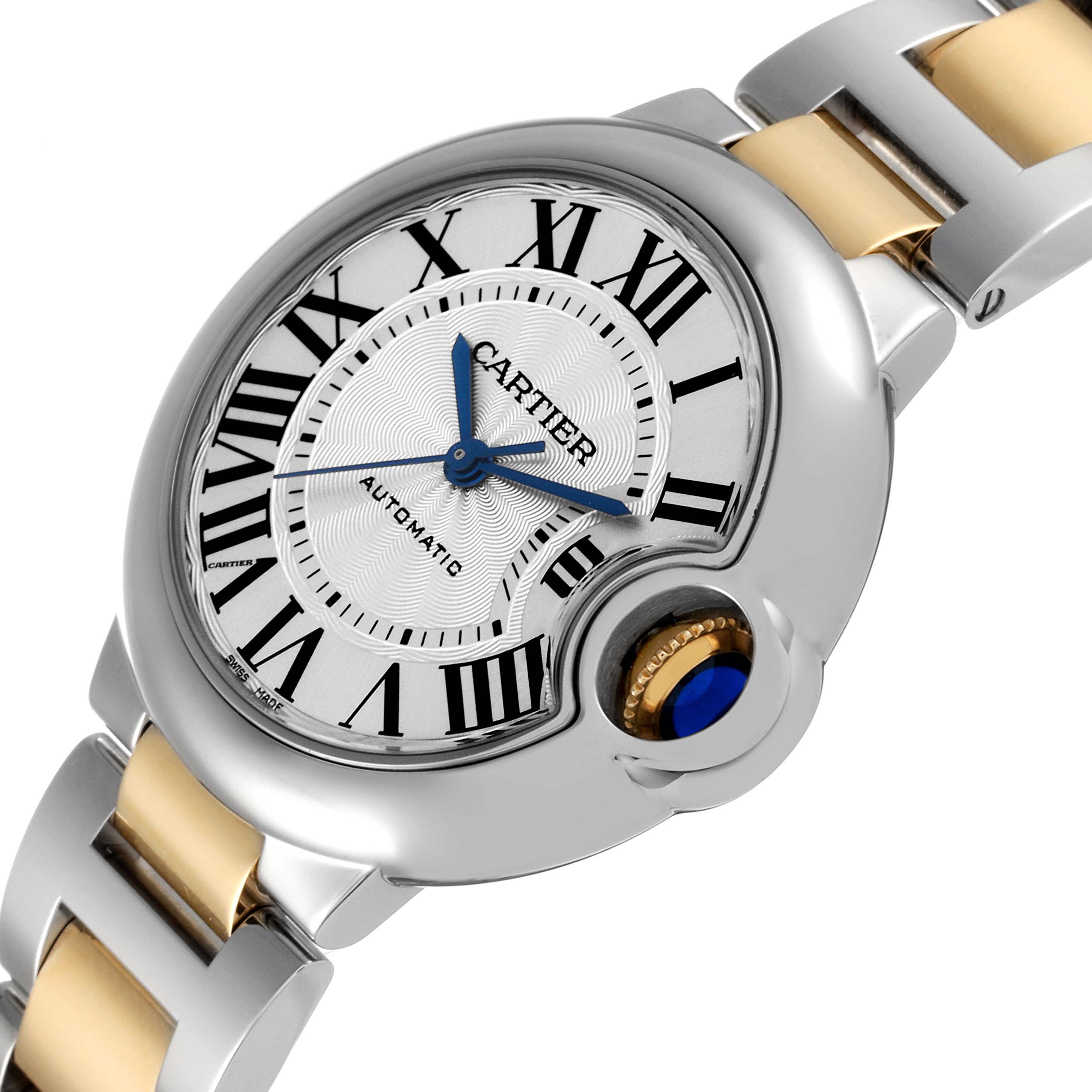 The image shows a close-up angle of the Cartier Ballon Bleu W2BB0029 Women
s Steel and Gold (two tone) Silver Dial W2BB0029 Women
s Steel and Gold (two tone) Silver Dial watch, highlighting its dial, blue hands, and crown.