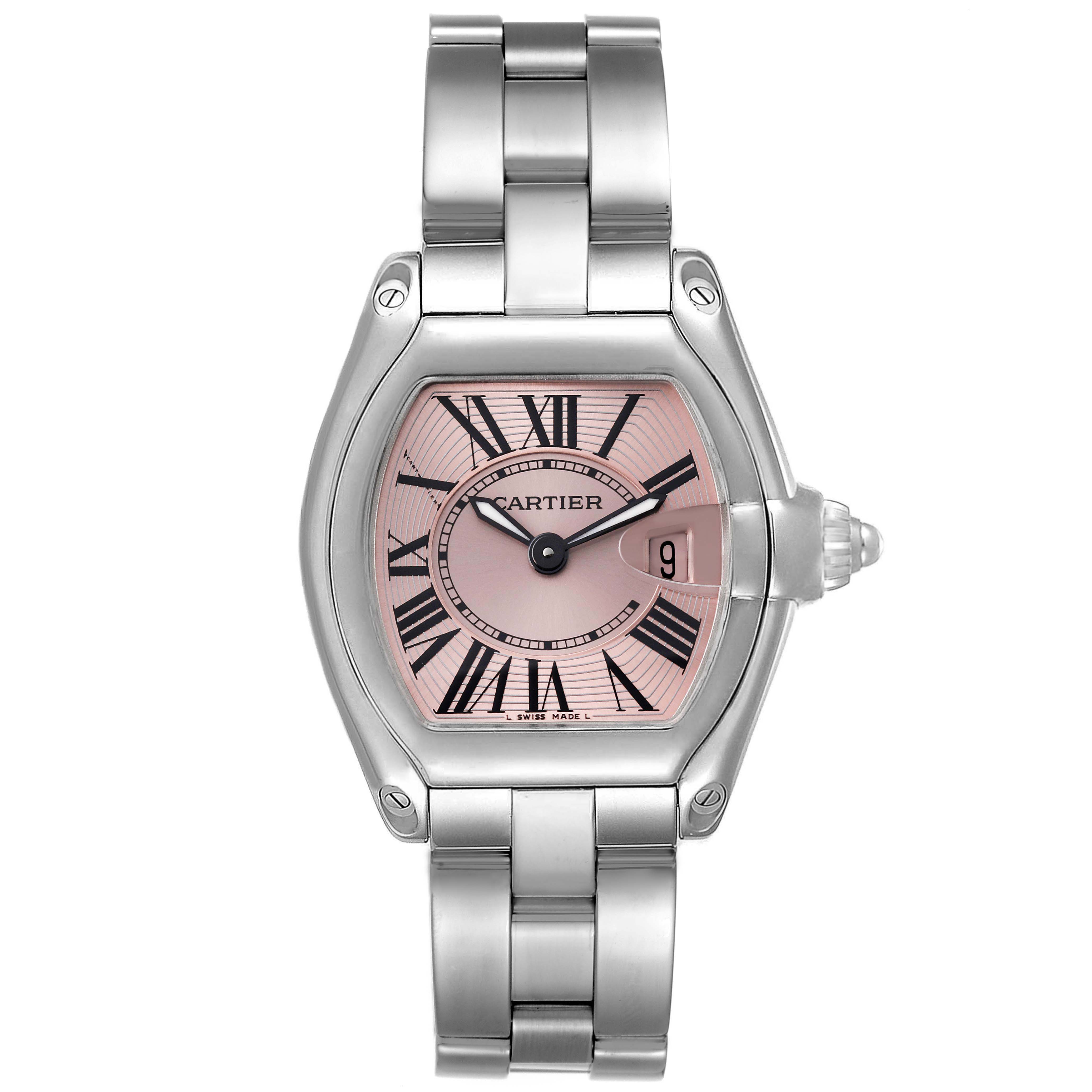 The image shows a Cartier Roadster W62017V3 Women's Stainless Steel Pink Dial W62017V3 Women's Stainless Steel Pink Dial watch with a pink dial, Roman numerals, and a stainless steel bracelet from a front angle.