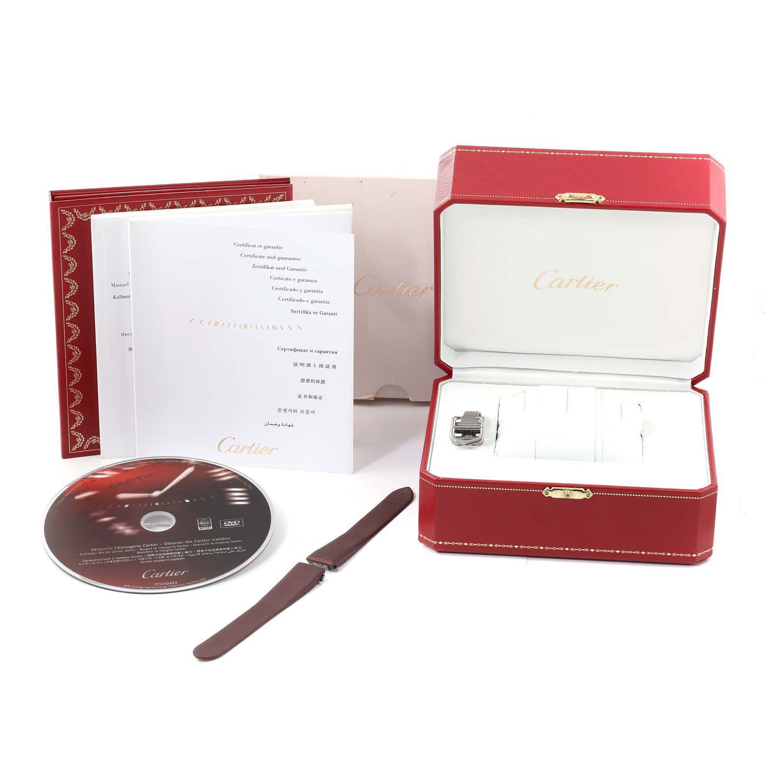 The image shows a Cartier Roadster W62017V3 Women's Stainless Steel Pink Dial W62017V3 Women's Stainless Steel Pink Dial watch box, manuals, a DVD, and an extra strap, all laid out for display.