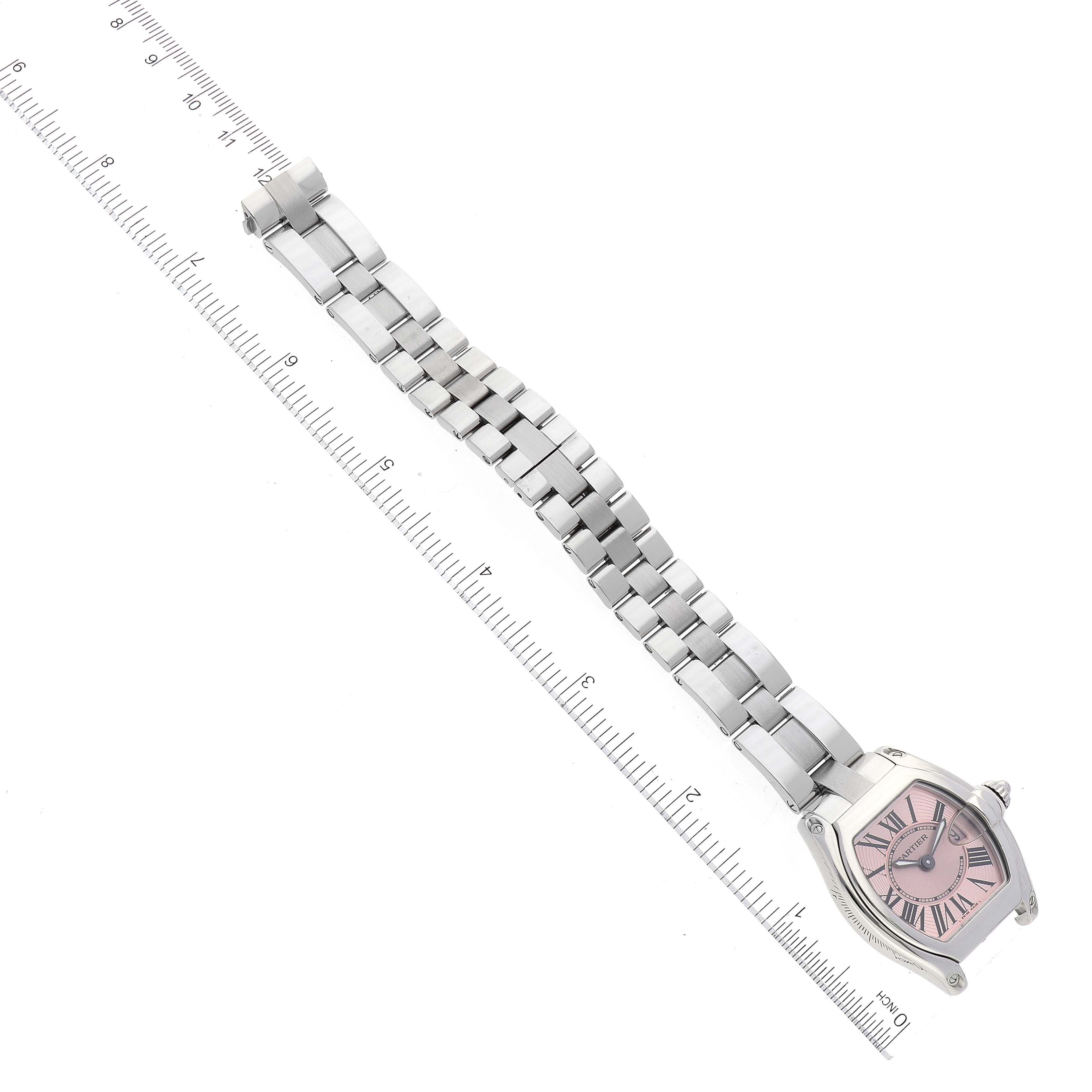 This image shows the full length of a Cartier Roadster W62017V3 Women's Stainless Steel Pink Dial W62017V3 Women's Stainless Steel Pink Dial watch, including its pink dial and metal bracelet, aligned with a ruler.