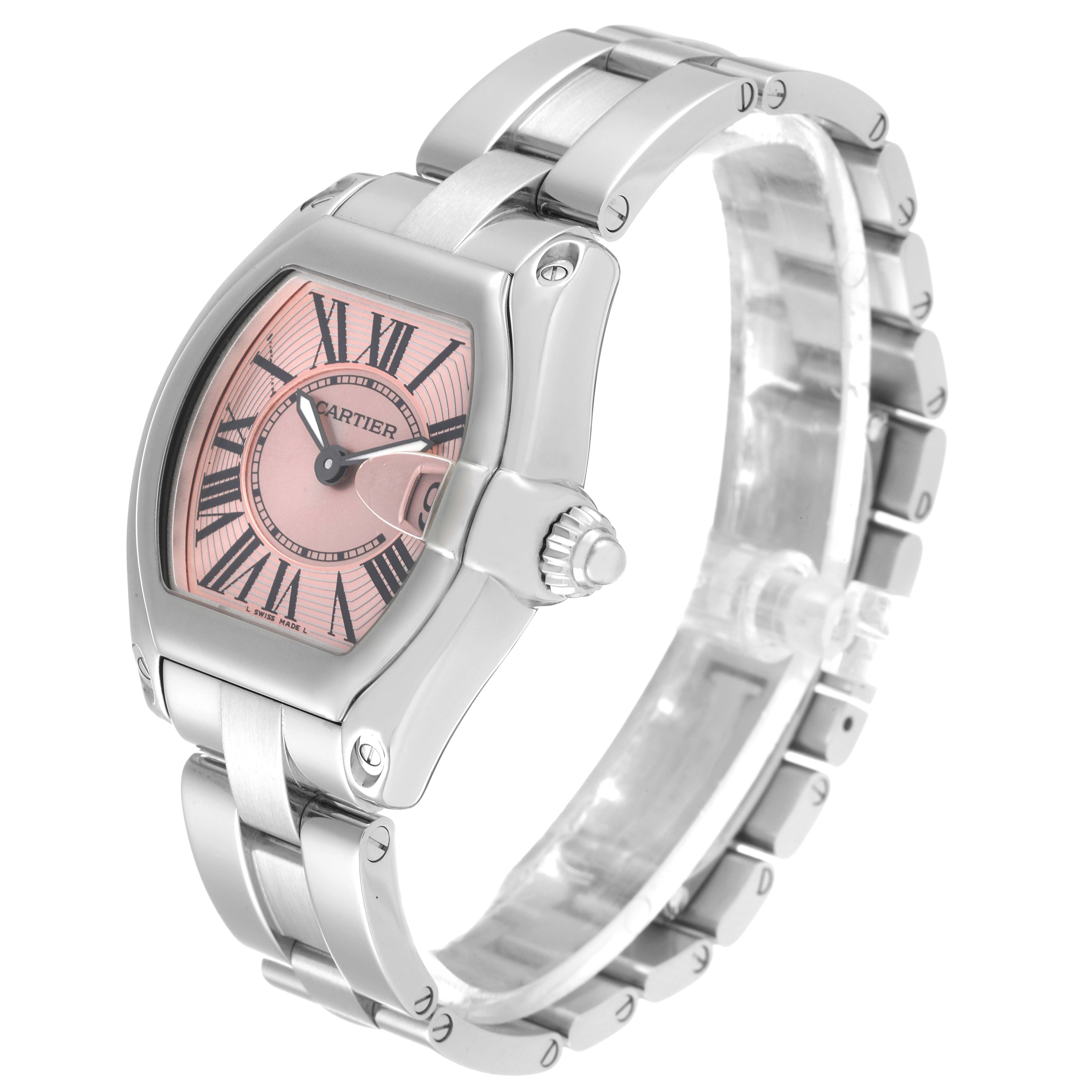 The Cartier Roadster W62017V3 Women's Stainless Steel Pink Dial W62017V3 Women's Stainless Steel Pink Dial watch is shown at a three-quarter angle, highlighting its pink dial, crown, and stainless steel bracelet.