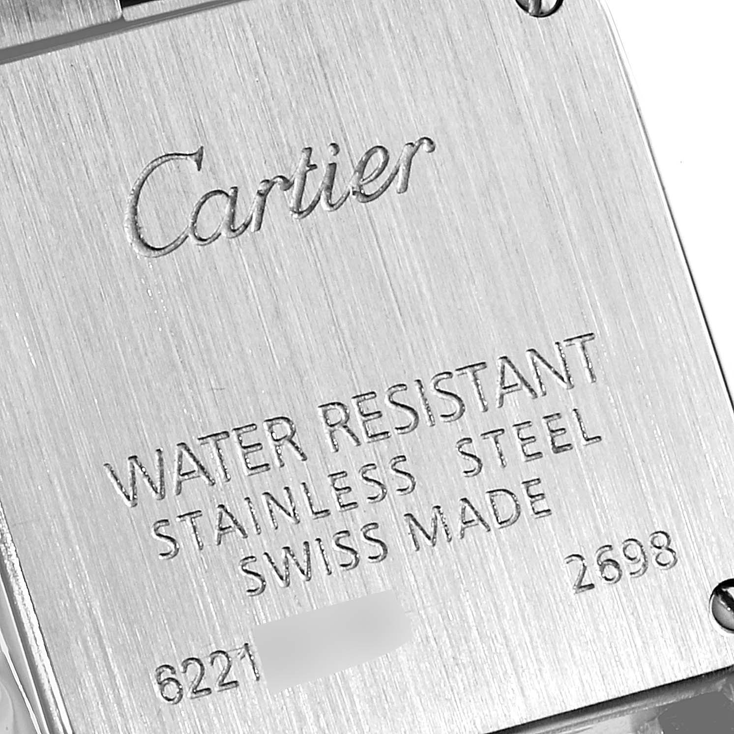 This is an angled close-up of the back casing of a Santos Demoiselle watch by Cartier, highlighting inscriptions detailing water resistance and materials.