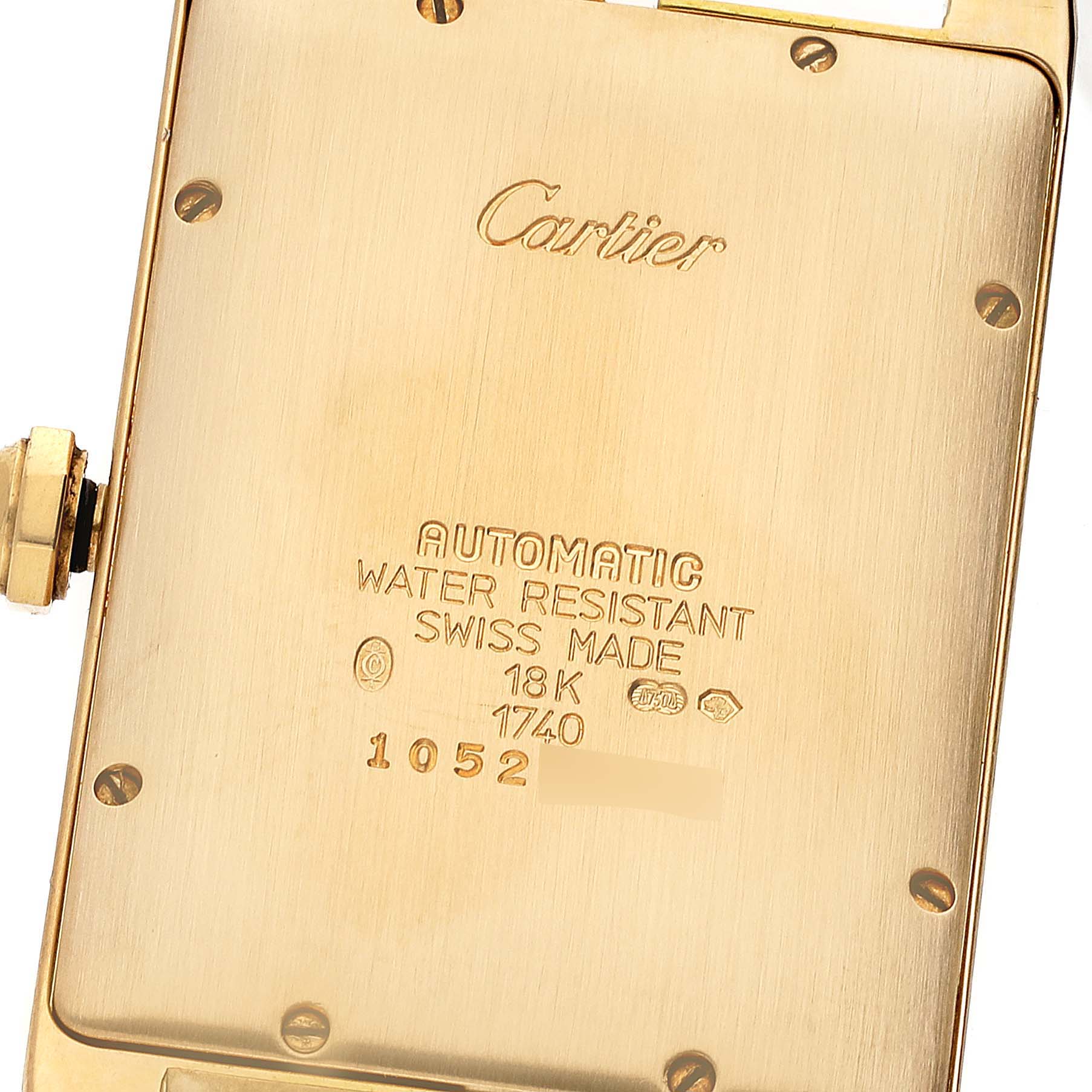 This image shows the back case of the Cartier Tank Americaine W2603156 Men
s Yellow Gold Silver Dial W2603156 Men
s Yellow Gold Silver Dial watch, highlighting the inscriptions and gold finish.