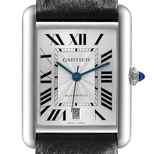 The image shows a close-up of the Cartier Tank Must watch face, crown with a blue gem, and part of the leather strap.