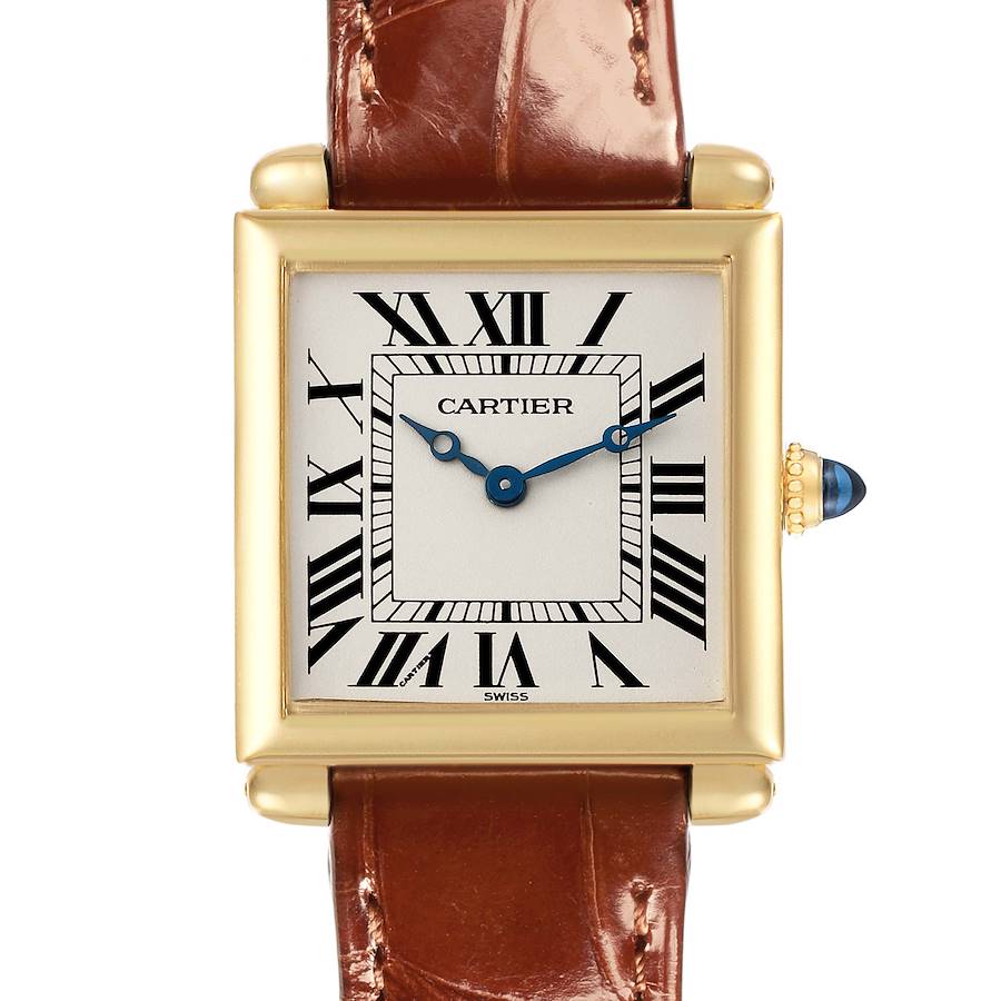 The Cartier Tank Obus watch is shown from the front, displaying the face, crown, and part of the leather strap.