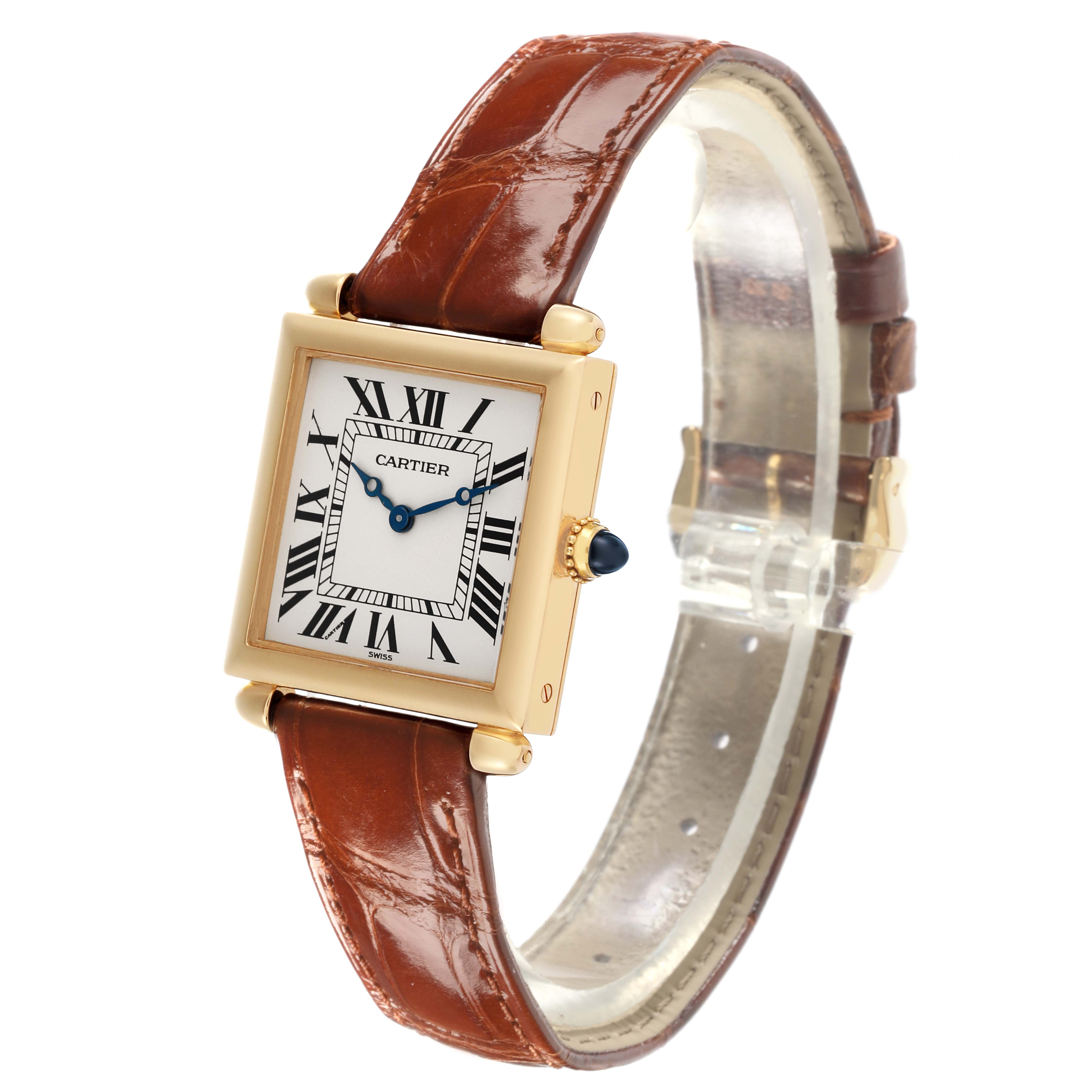 The Cartier Tank Obus W1512256 Women
s Yellow Gold Silver Dial W1512256 Women
s Yellow Gold Silver Dial watch is shown from an angled side view, highlighting the face, crown, and leather strap.