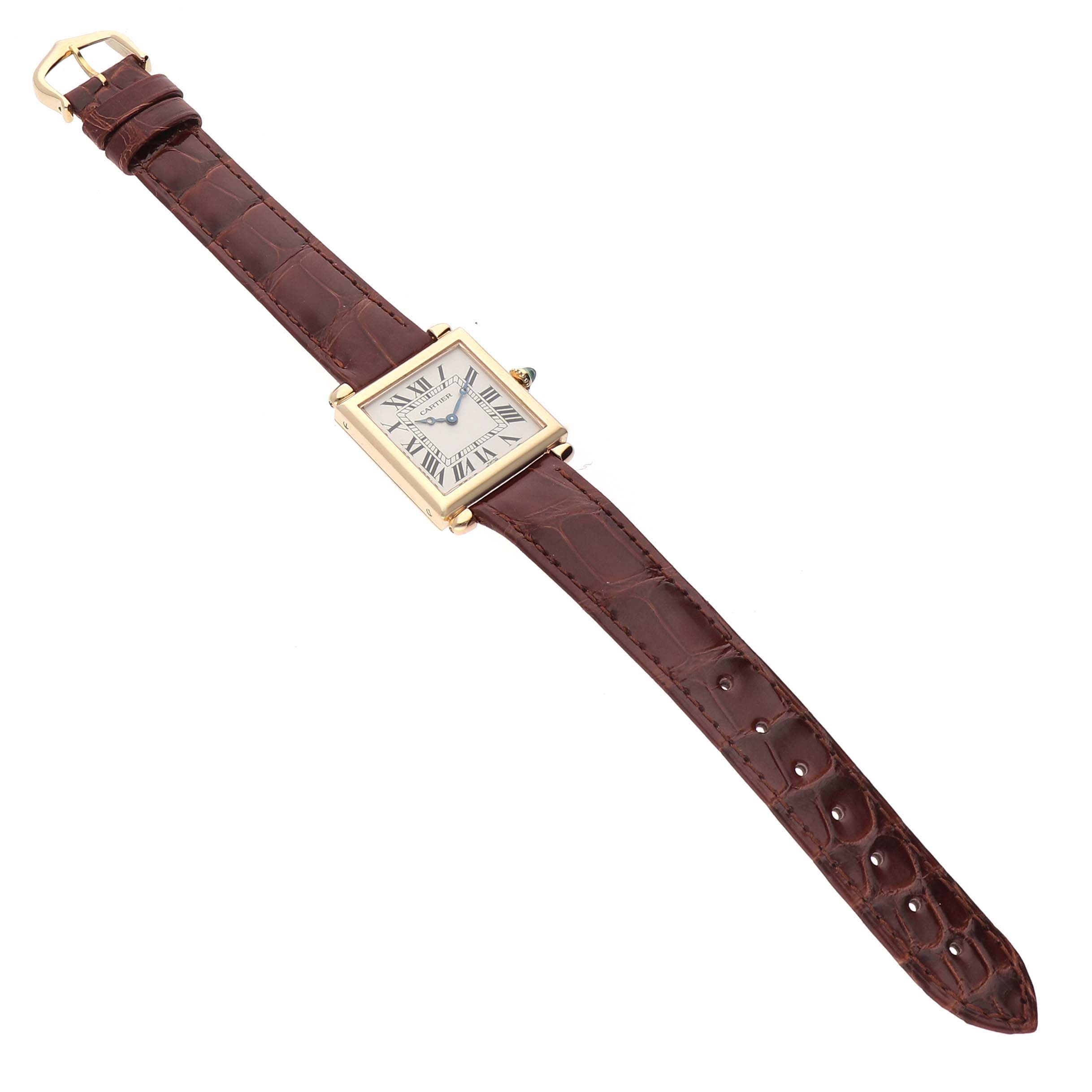The Cartier Tank Obus W1512256 Women
s Yellow Gold Silver Dial W1512256 Women
s Yellow Gold Silver Dial watch is shown from an angled top view, displaying the square dial and brown leather strap.