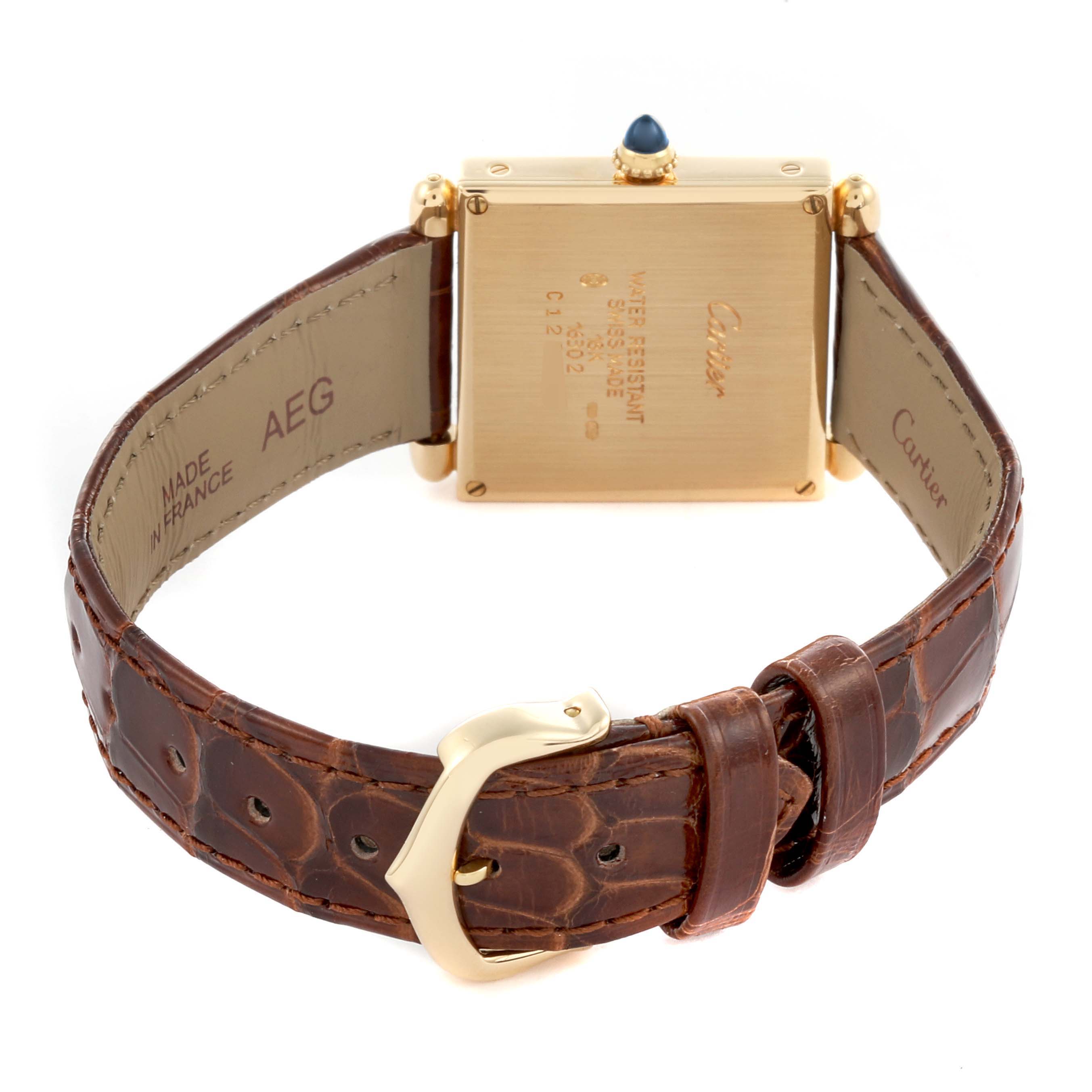 The Cartier Tank Obus W1512256 Women
s Yellow Gold Silver Dial W1512256 Women
s Yellow Gold Silver Dial watch is shown from the back, displaying its case, strap, and buckle.