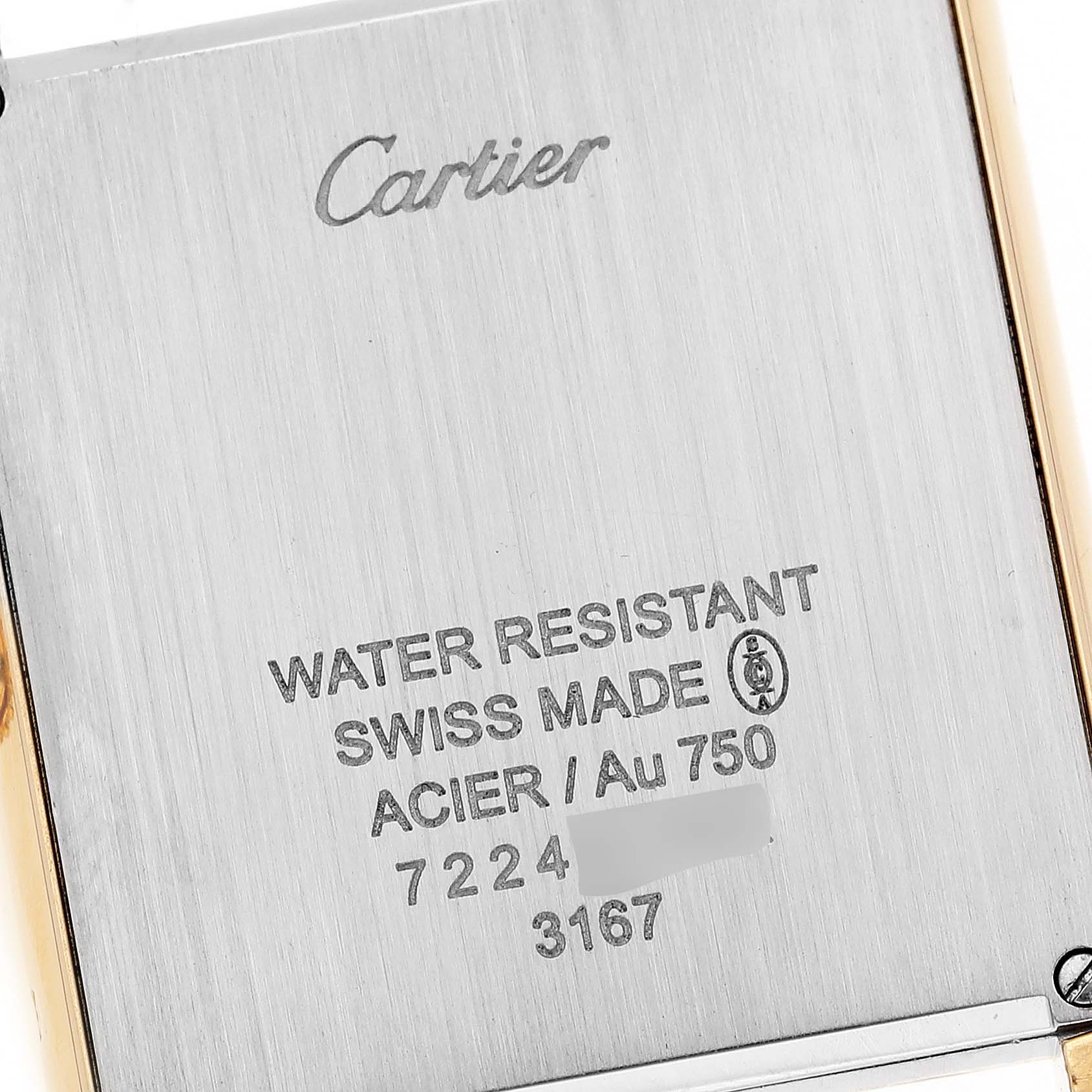 The image shows a close-up of the back case of a Cartier Tank Solo W5200004 Men's Steel and Gold (two tone) Blue Dial W5200004 Men's Steel and Gold (two tone) Blue Dial watch, featuring engraved details and branding.