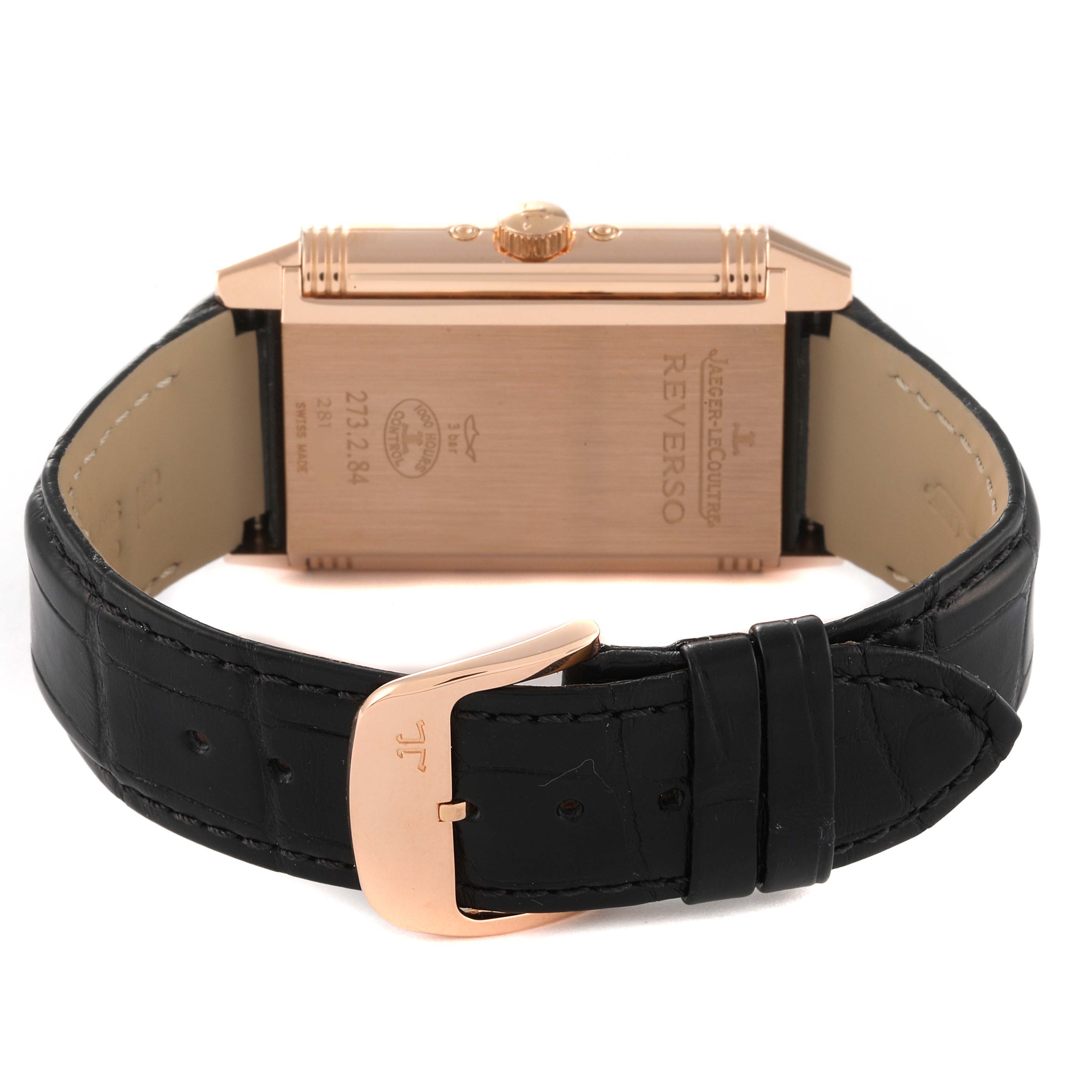 The image shows the Jaeger LeCoultre Reverso Q3752520 Men's Rose Gold Silver Dial Q3752520 Men's Rose Gold Silver Dial watch from a rear angle highlighting the case back and leather strap with buckle.