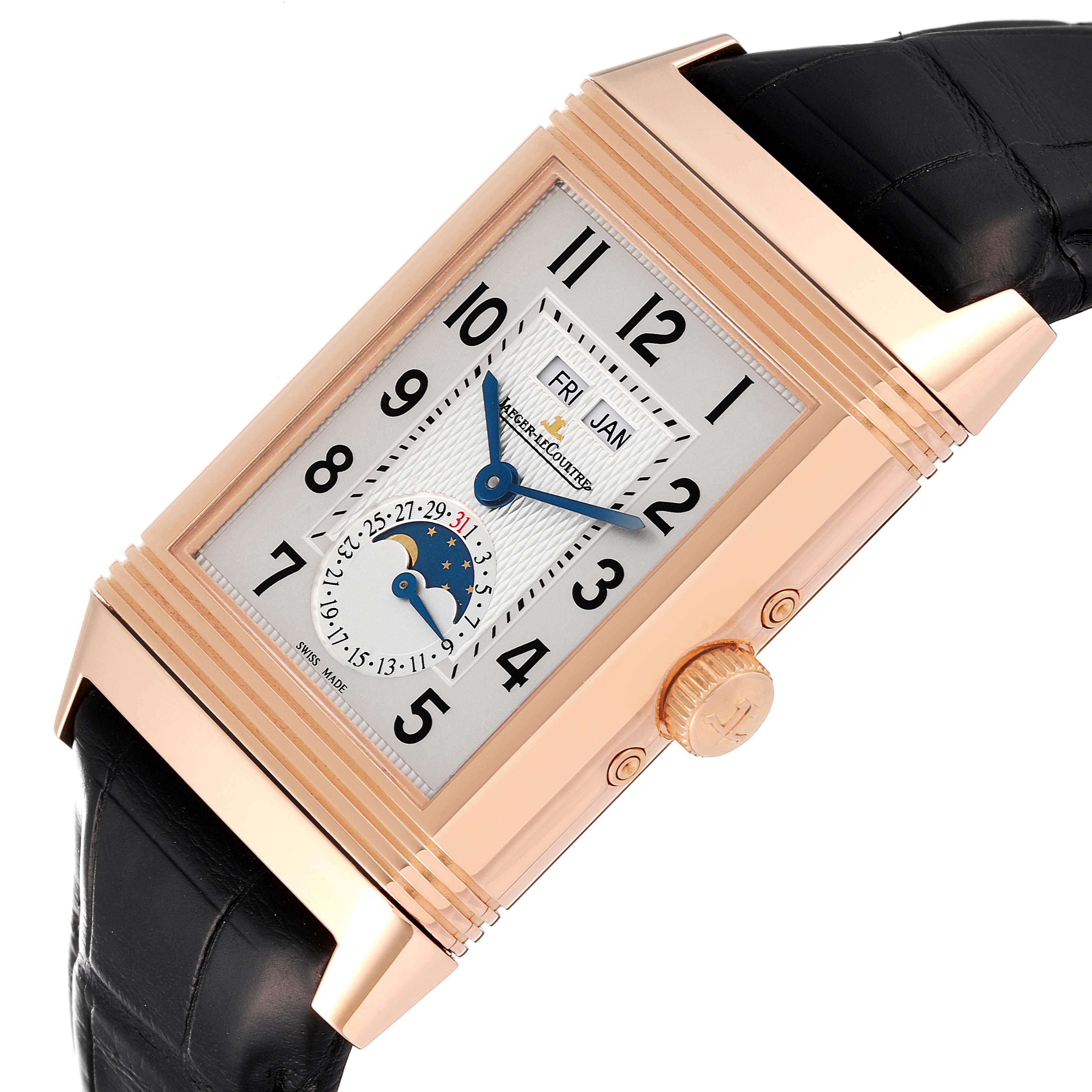 The Jaeger-LeCoultre Reverso watch is shown at an angle highlighting the dial, crown, and part of the leather strap.