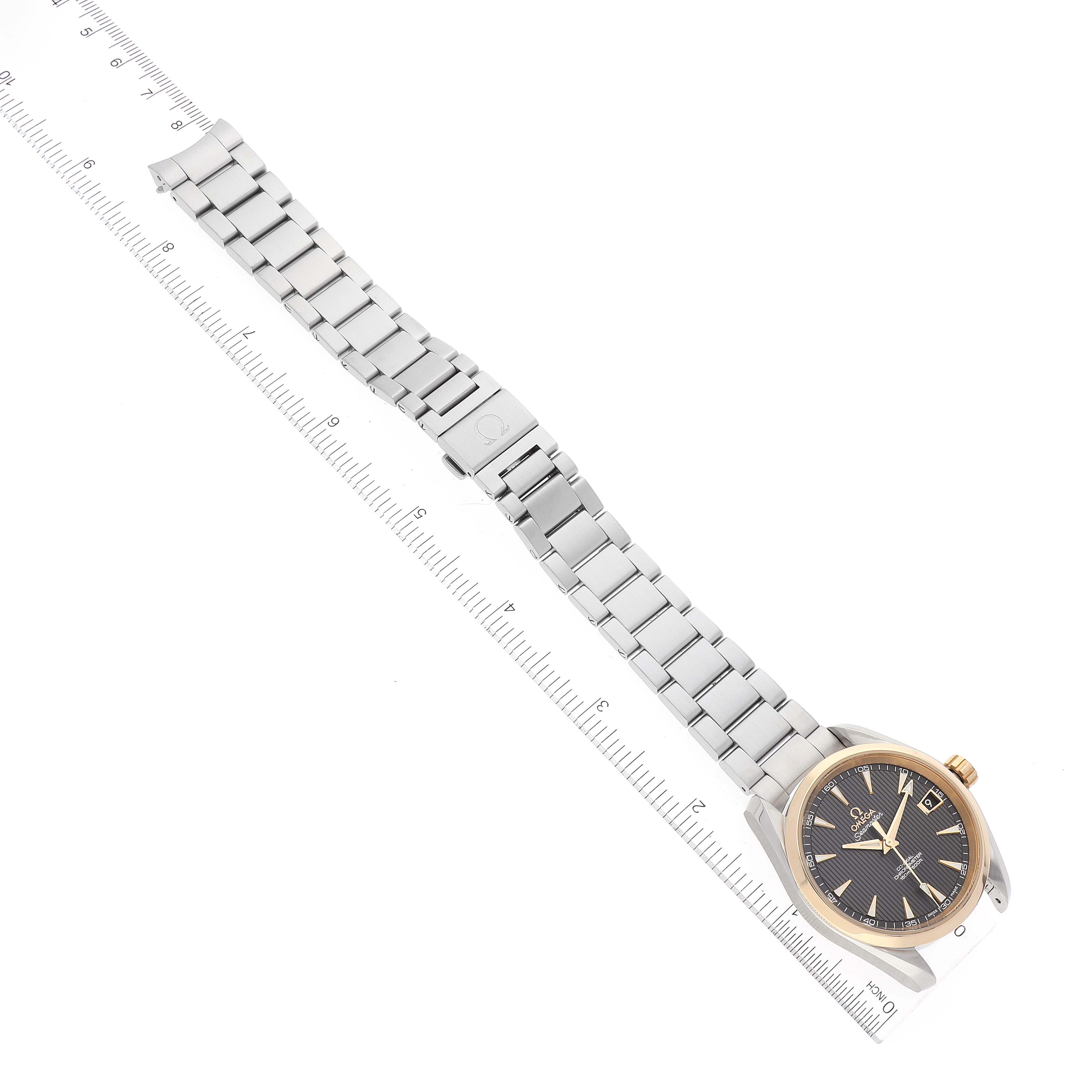 The image shows an Omega Aqua Terra 231.20.39.21.06.004 Men's Stainless Steel Grey Dial 231.20.39.21.06.004 Men's Stainless Steel Grey Dial watch laid flat with its metal bracelet fully extended diagonally along a ruler.