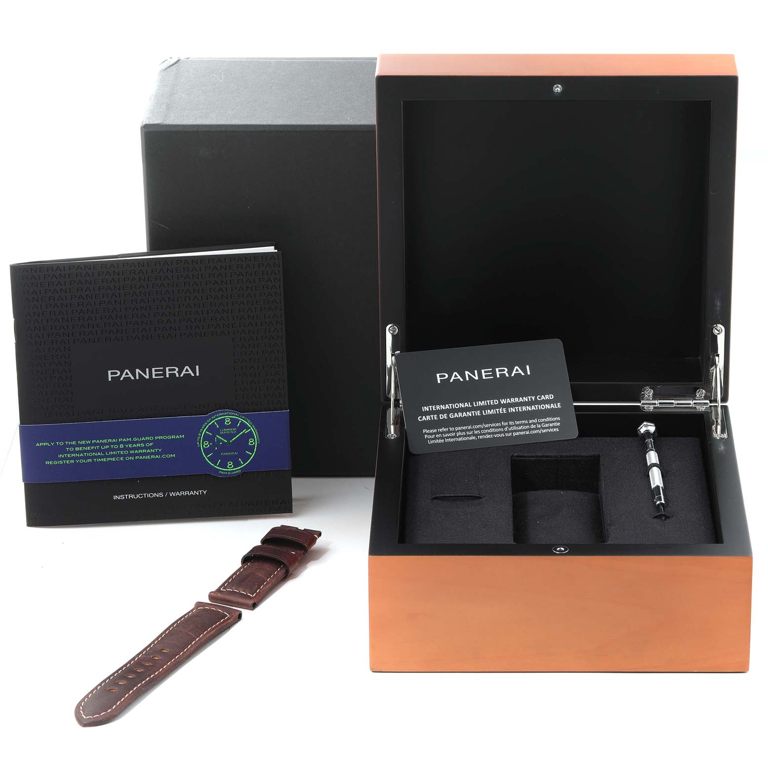 The image shows a Panerai Luminor PAM00795 Men
s Stainless Steel Black Dial PAM00795 Men
s Stainless Steel Black Dial watch accessory set including a warranty card, instruction booklet, additional strap, and storage box.