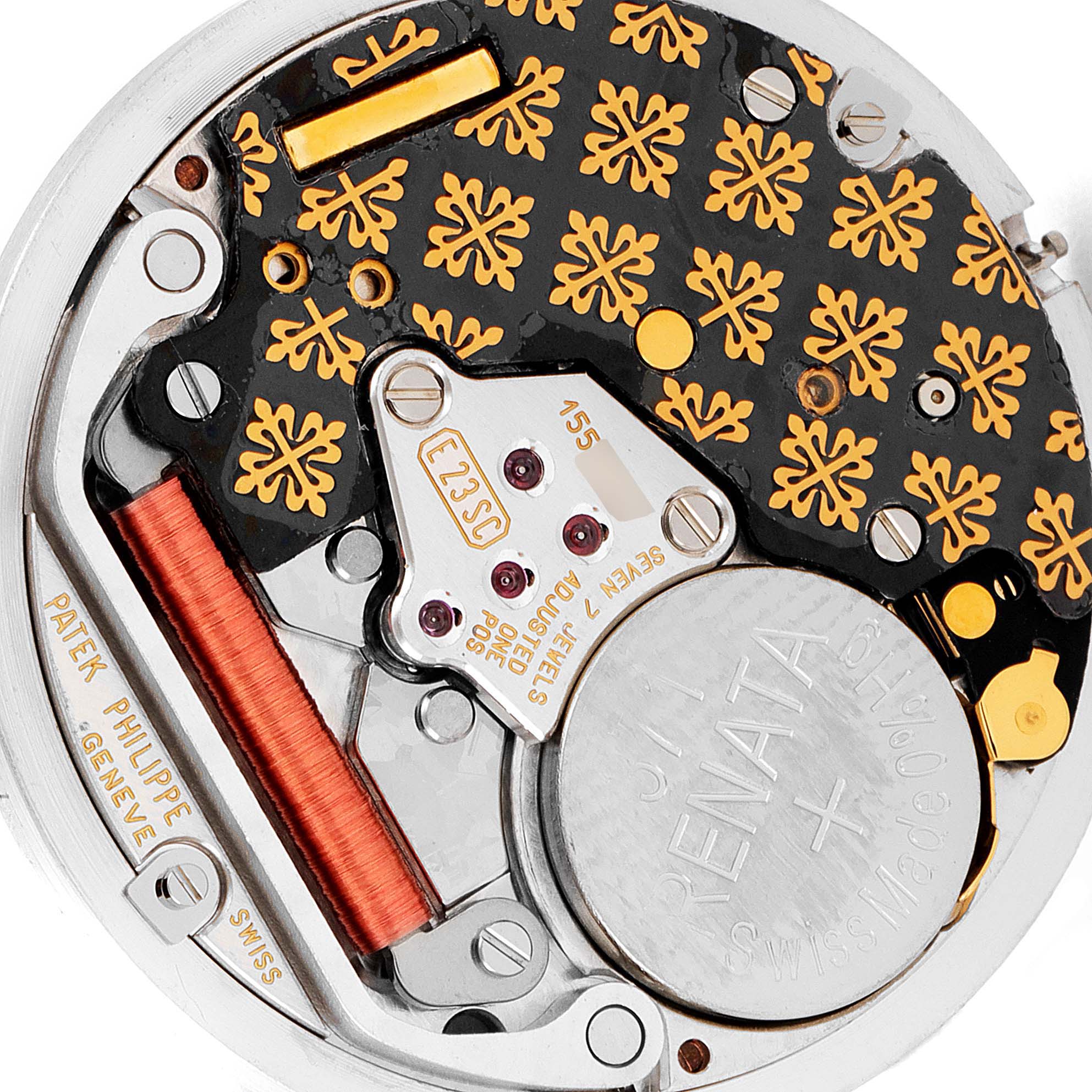The image shows a macro view of the intricate movement components and battery of the Patek Philippe Nautilus 3900/003 Women's Yellow Gold Champagne Dial 3900/003 Women's Yellow Gold Champagne Dial watch.