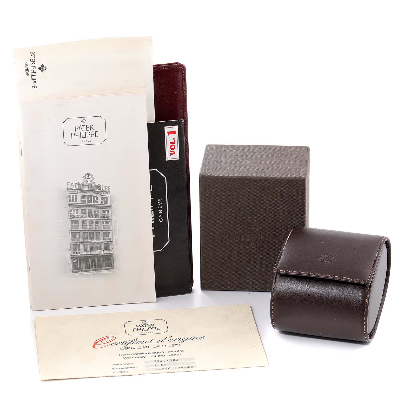 The image shows various accessories of a Patek Philippe Nautilus 3900/003 Women's Yellow Gold Champagne Dial 3900/003 Women's Yellow Gold Champagne Dial watch, including the box, certificate, manual, and leather watch case.