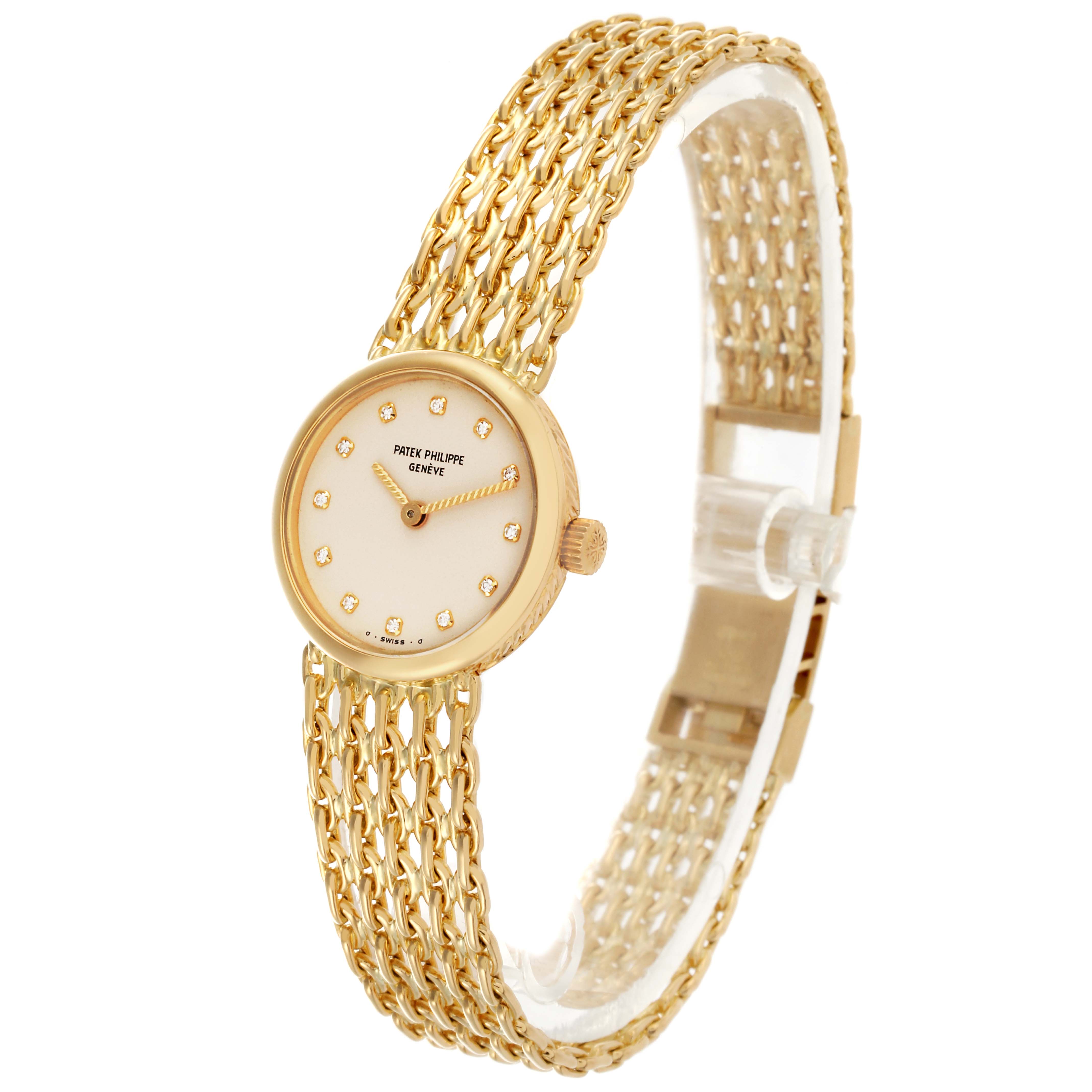 The Vintage Patek Philippe watch is shown at a slight angle, displaying the gold mesh bracelet, round dial, and diamond markers.