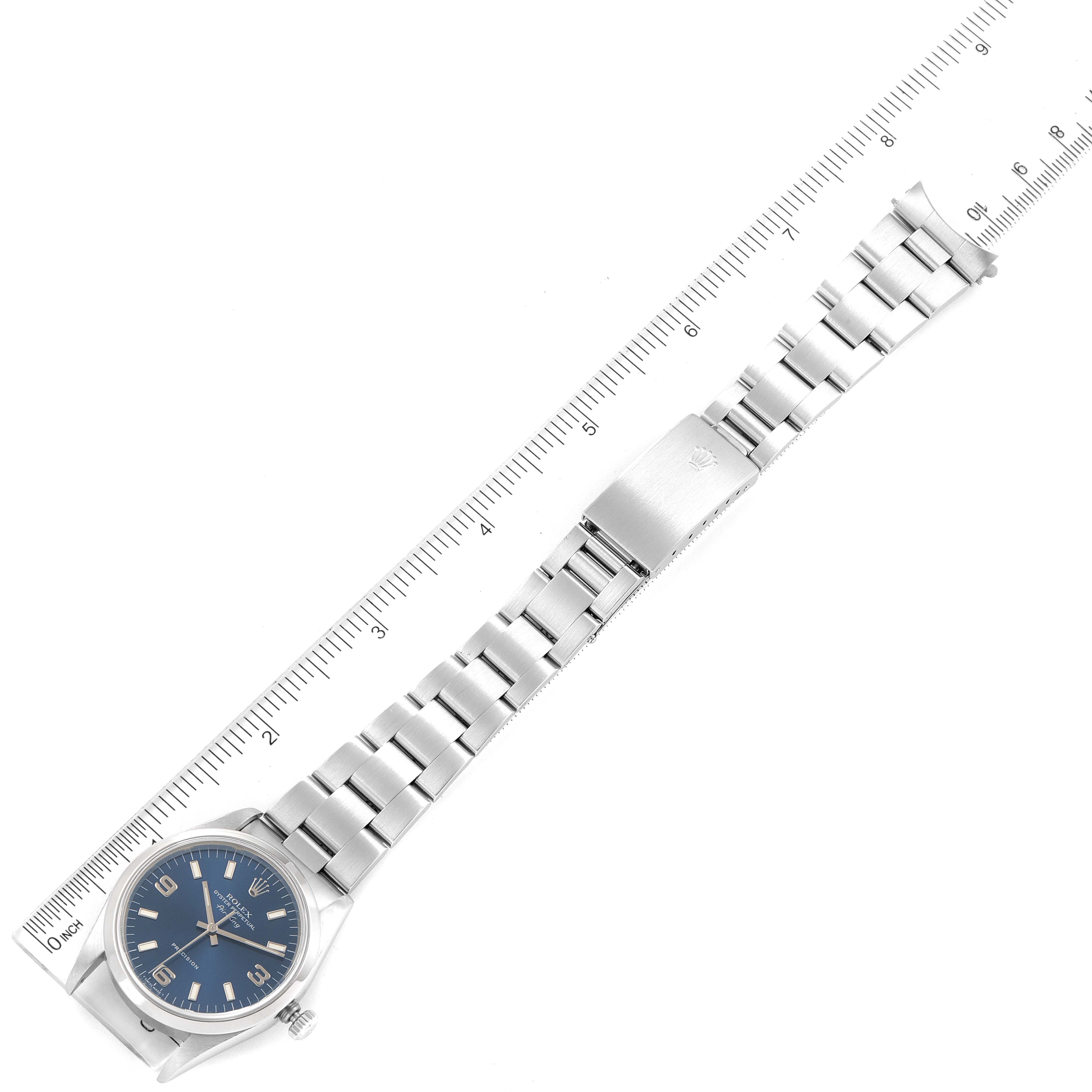 The image displays a Rolex Air-King 14000 Men's Stainless Steel Blue Dial 14000 Men's Stainless Steel Blue Dial watch laid flat, showing the face, band, and clasp alongside a ruler for measurement.