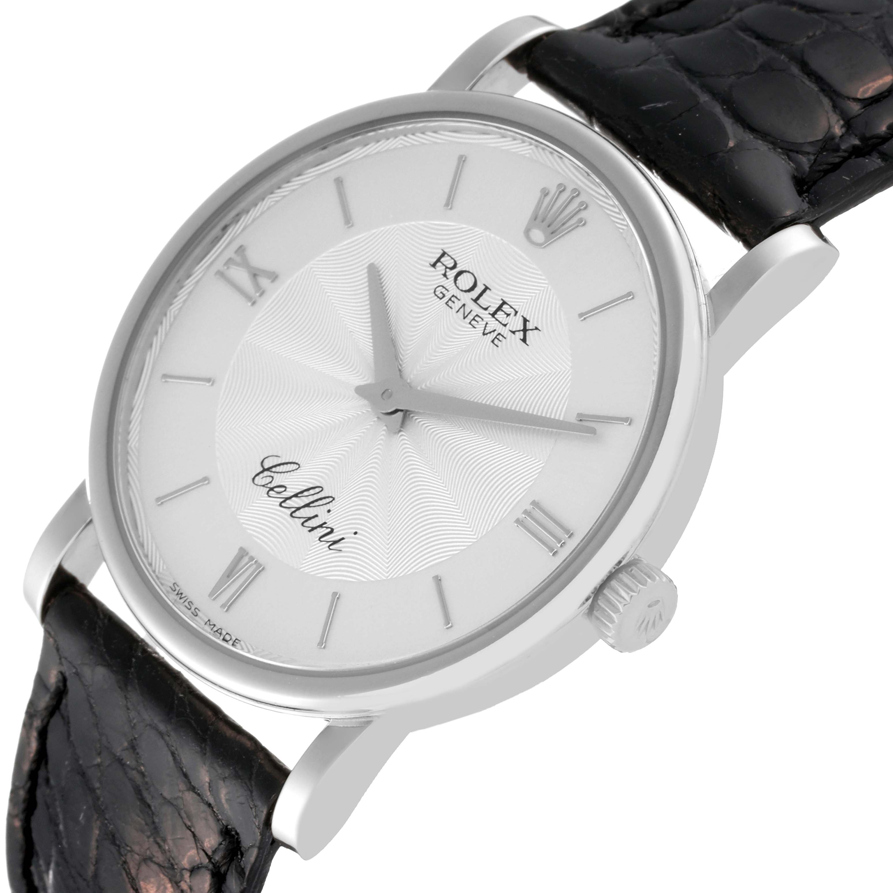 The image shows a Rolex Cellini 5115/9 Men
s White Gold Silver Dial 5115/9 Men
s White Gold Silver Dial watch at an angle, displaying the face, crown, and part of the black leather strap.