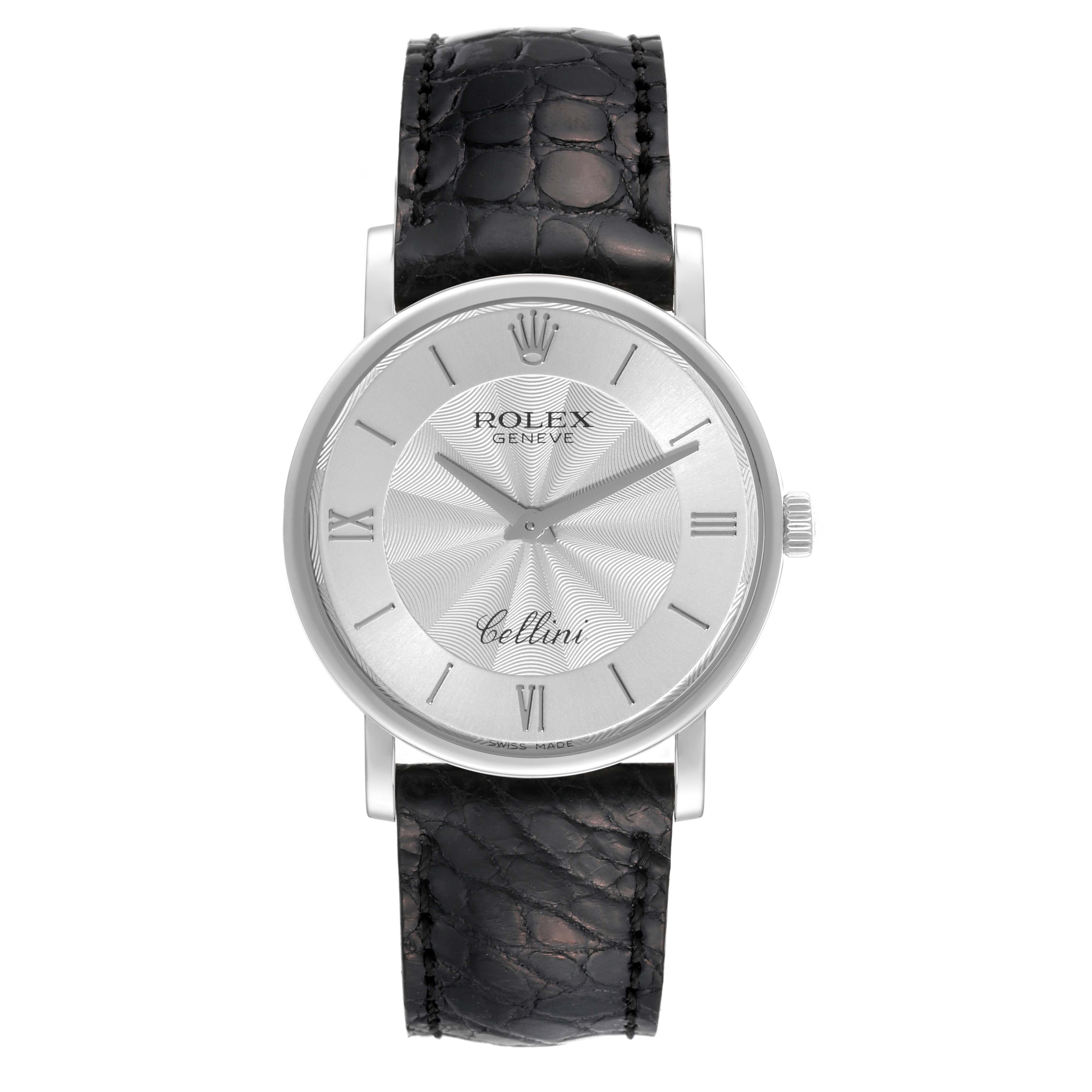 The Rolex Cellini 5115/9 Men
s White Gold Silver Dial 5115/9 Men
s White Gold Silver Dial watch is shown from a top-down angle, displaying its dial, case, and black leather strap.