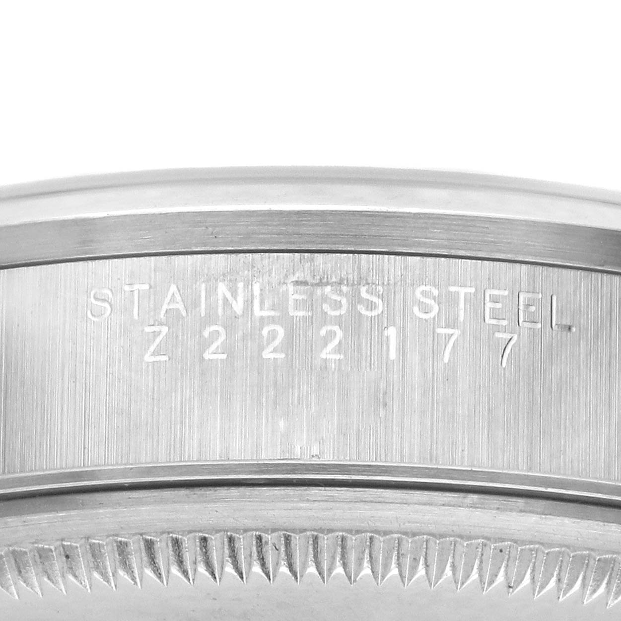 The image shows a close-up of the side of the Rolex Date 15200 Men's Stainless Steel Blue Dial 15200 Men's Stainless Steel Blue Dial model, highlighting the stainless steel case and engraved serial number.