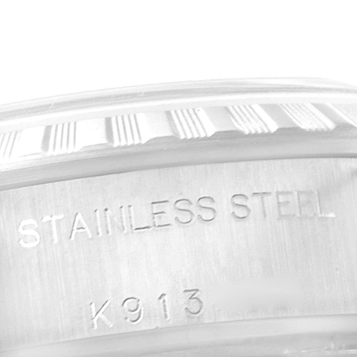 The image shows a close-up of the side of a Rolex Date 79240 Women
s Stainless Steel Silver Dial 79240 Women
s Stainless Steel Silver Dial model, highlighting its stainless steel material and part of its fluted bezel.