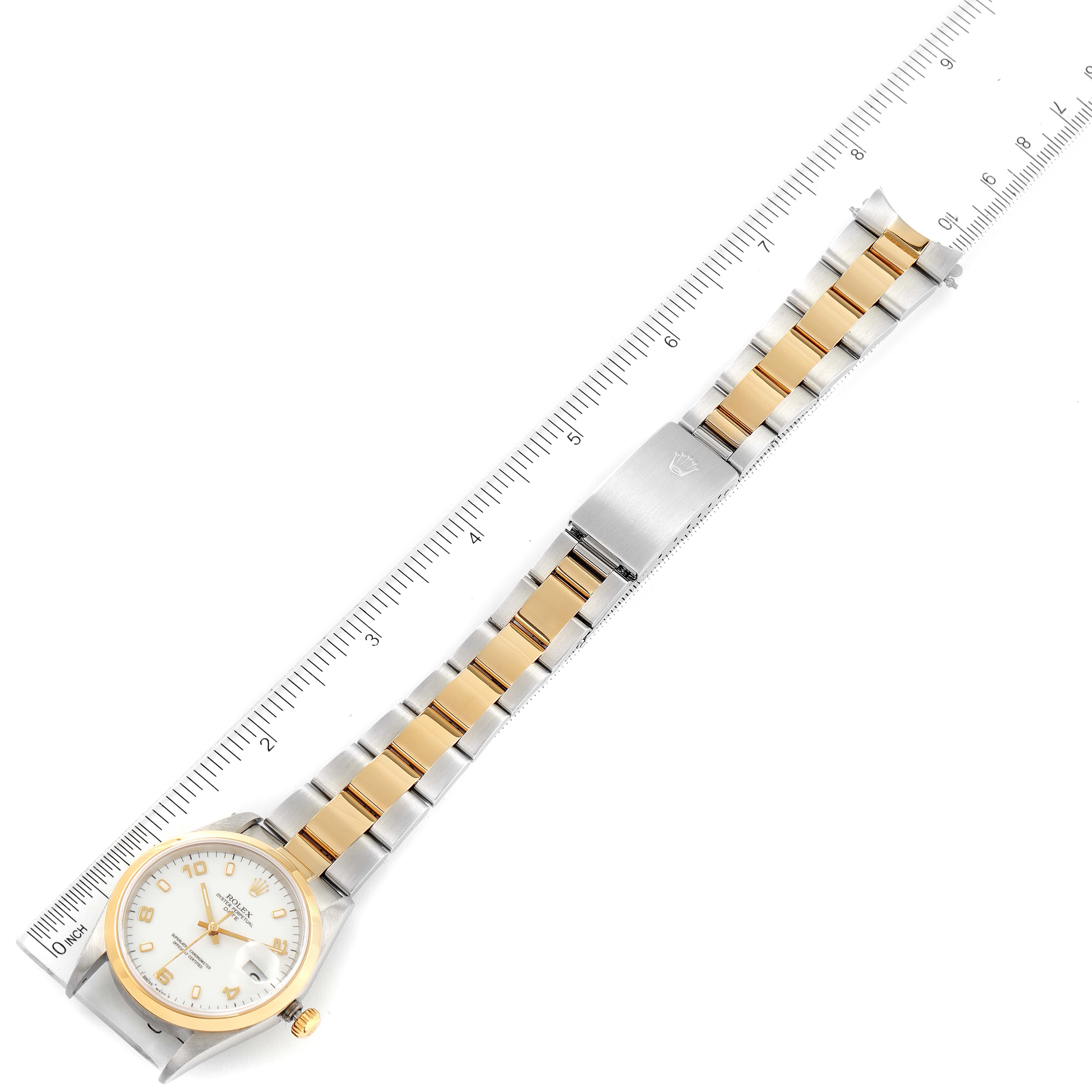 The image shows a Rolex Date 15203 Men's Steel and Gold (two tone) White Dial 15203 Men's Steel and Gold (two tone) White Dial model watch laid flat with its dial, bracelet, clasp, and crown visible alongside a ruler.
