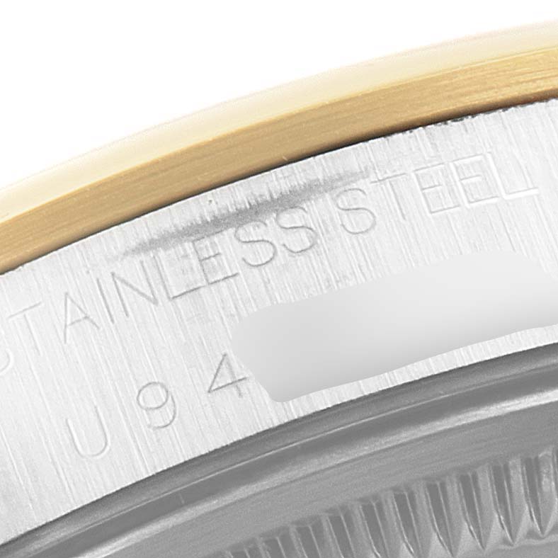 This close-up image shows the edge of the bezel and the stainless steel casing of a Rolex Date 15203 Men's Steel and Gold (two tone) White Dial 15203 Men's Steel and Gold (two tone) White Dial model watch.