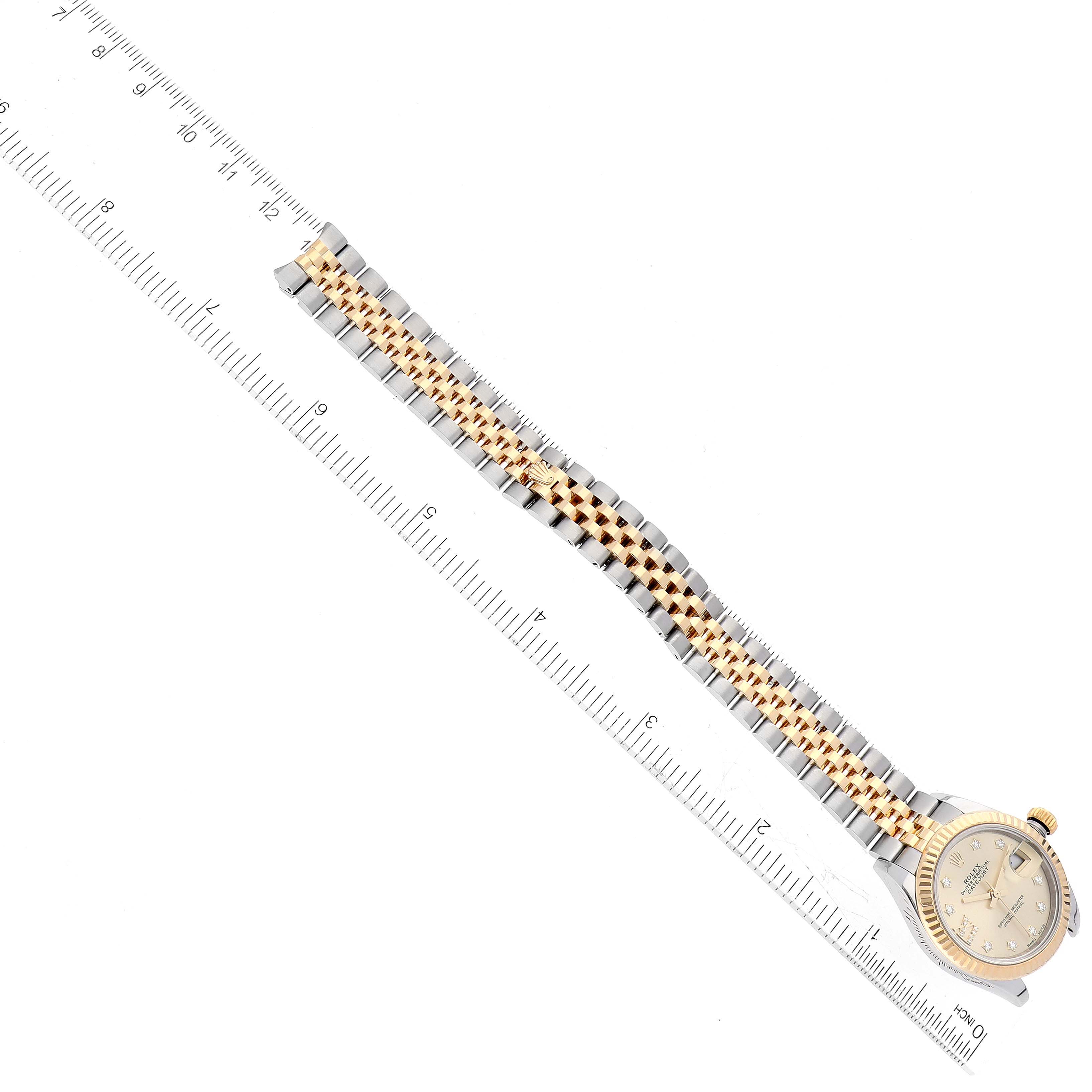 The image shows a Rolex Datejust 279173 Women's Steel and Gold (two tone) Champagne Dial 279173 Women's Steel and Gold (two tone) Champagne Dial watch laid flat, displaying the face and full length of the metal bracelet with a measuring ruler.