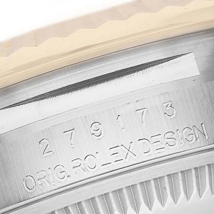 This close-up image shows the engraved model number and "ORIG. ROLEX DESIGN" on the case of a Rolex Datejust 279173 Women's Steel and Gold (two tone) Champagne Dial 279173 Women's Steel and Gold (two tone) Champagne Dial watch.