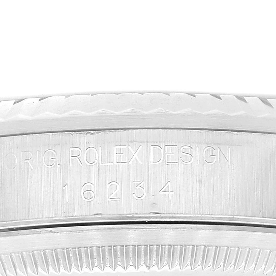 The image shows a close-up of the case side and bezel with "ORIG. ROLEX DESIGN 16234" engraved on a Rolex Datejust 16234 Men's Stainless Steel Blue Dial 16234 Men's Stainless Steel Blue Dial model.