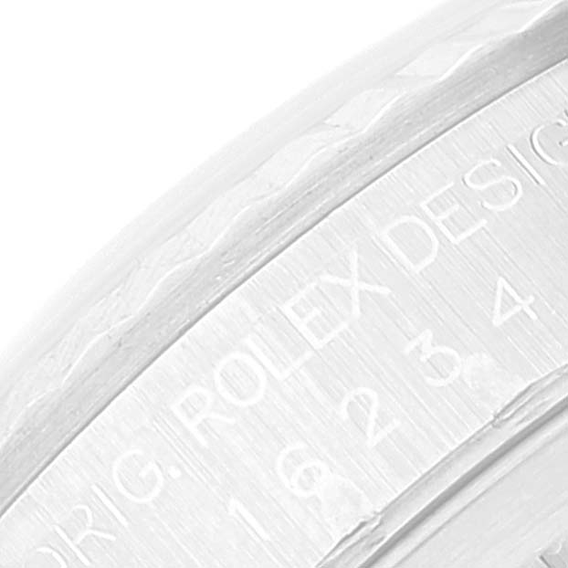 The image shows a close-up of the engraved bezel of the Rolex Datejust 16234 Men's Stainless Steel Blue Dial 16234 Men's Stainless Steel Blue Dial watch.