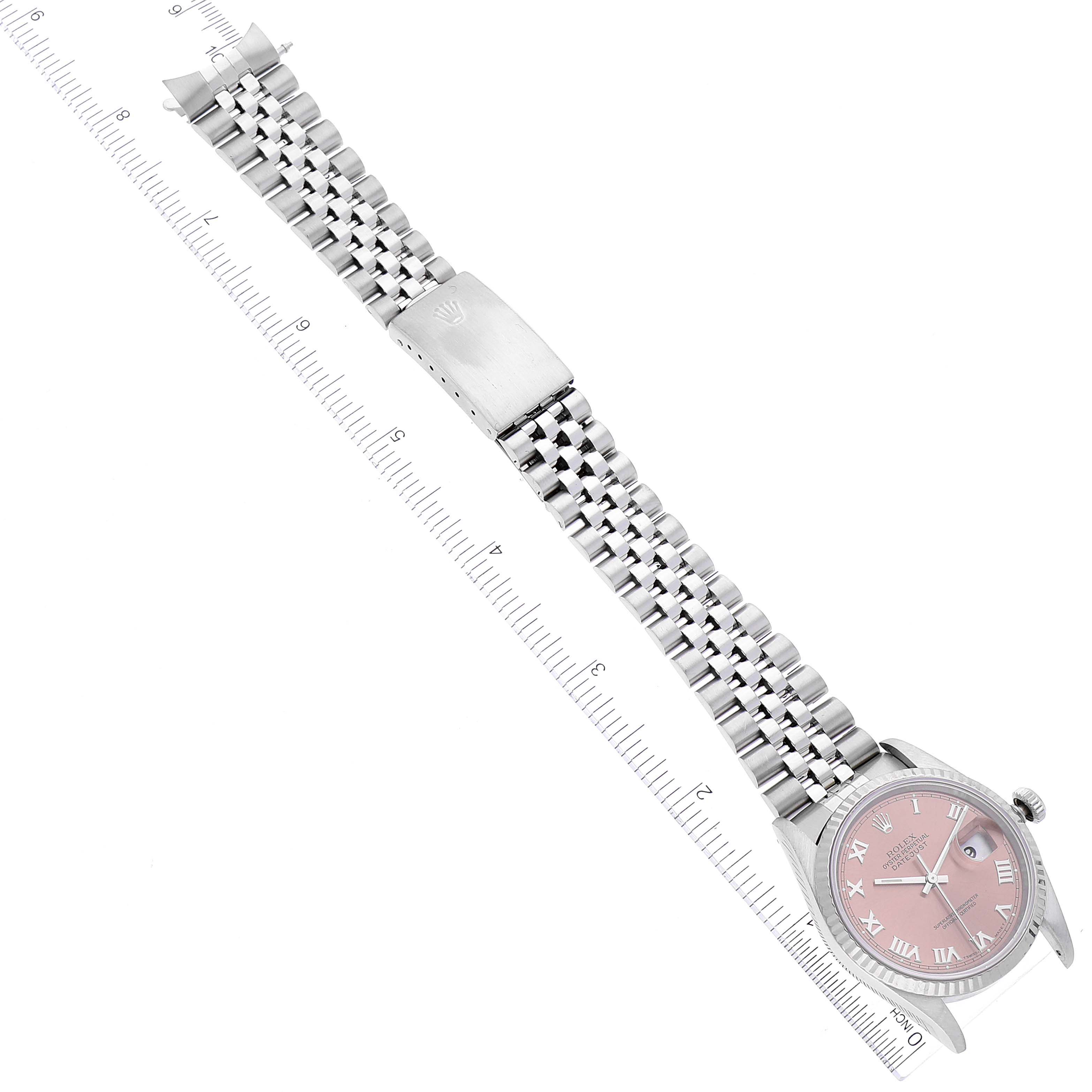 The image shows a full view of a Rolex Datejust 16234 Men's Stainless Steel Pink Dial 16234 Men's Stainless Steel Pink Dial watch laid flat, including the bracelet and clasp, alongside a measurement ruler.
