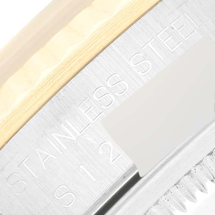This image shows a close-up of the side engraving and part of the fluted bezel of a Rolex Datejust 16233 Men's Steel and Gold (two tone) Blue Dial 16233 Men's Steel and Gold (two tone) Blue Dial watch.