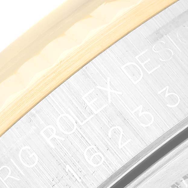 This close-up image shows the bezel and part of the edge of the dial of a Rolex Datejust 16233 Men's Steel and Gold (two tone) Blue Dial 16233 Men's Steel and Gold (two tone) Blue Dial watch, displaying the engraving.