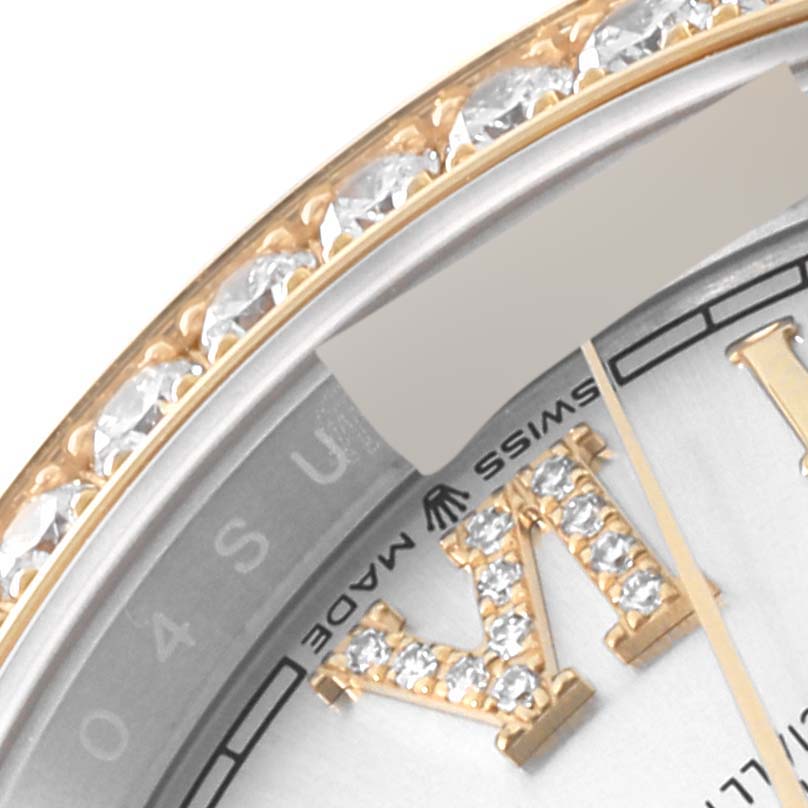 This close-up image of the Rolex Datejust 126283 Men's Steel and Gold (two tone) Silver Dial 126283 Men's Steel and Gold (two tone) Silver Dial watch shows part of the bezel, dial, and Roman numeral VI with diamond accents.