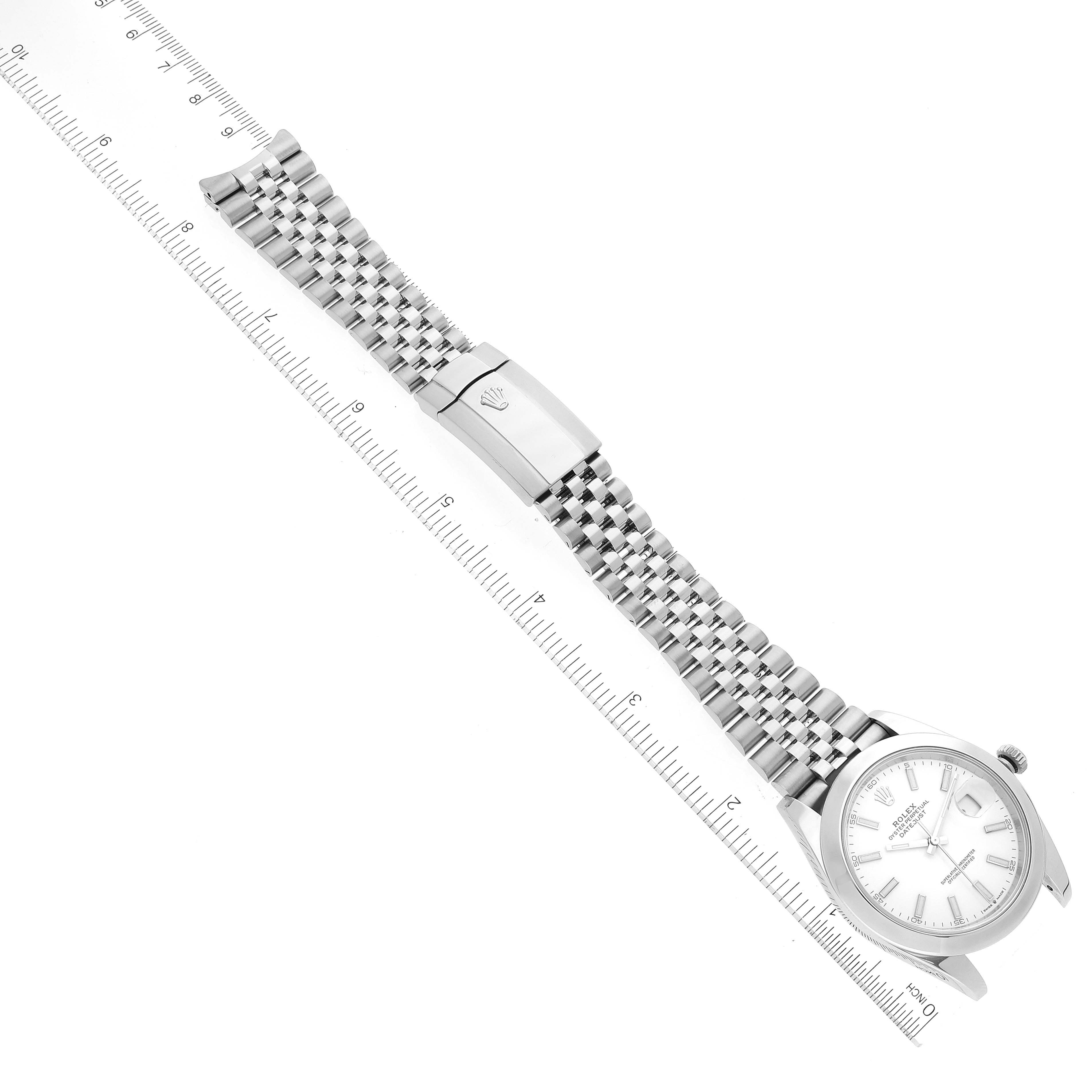 The image shows a Rolex Datejust 41 126300 Men's Stainless Steel White Dial 126300 Men's Stainless Steel White Dial model watch laid flat, displaying the face, bezel, and Jubilee bracelet with a clasp, alongside a ruler.