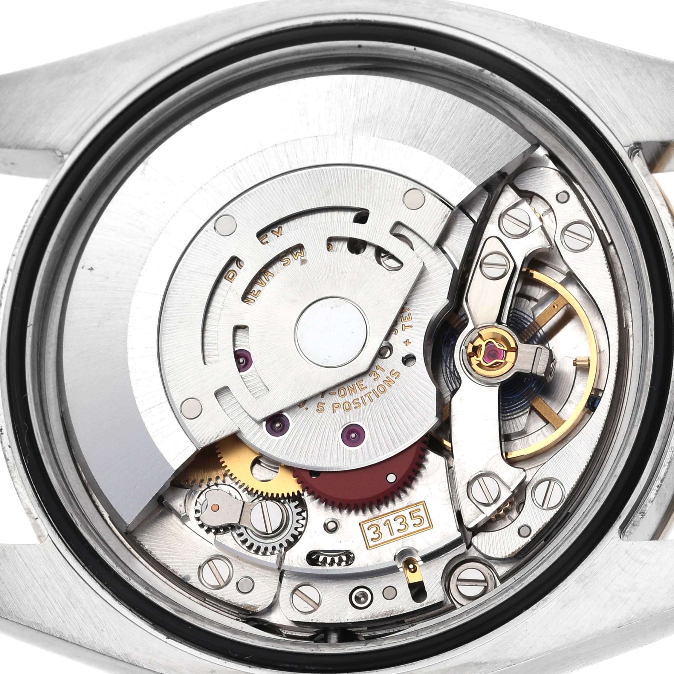 The image shows the movement of the Rolex Datejust 116243 Men
s Steel and Gold (two tone) Silver Dial 116243 Men
s Steel and Gold (two tone) Silver Dial watch from a top-down angle, highlighting its internal components.