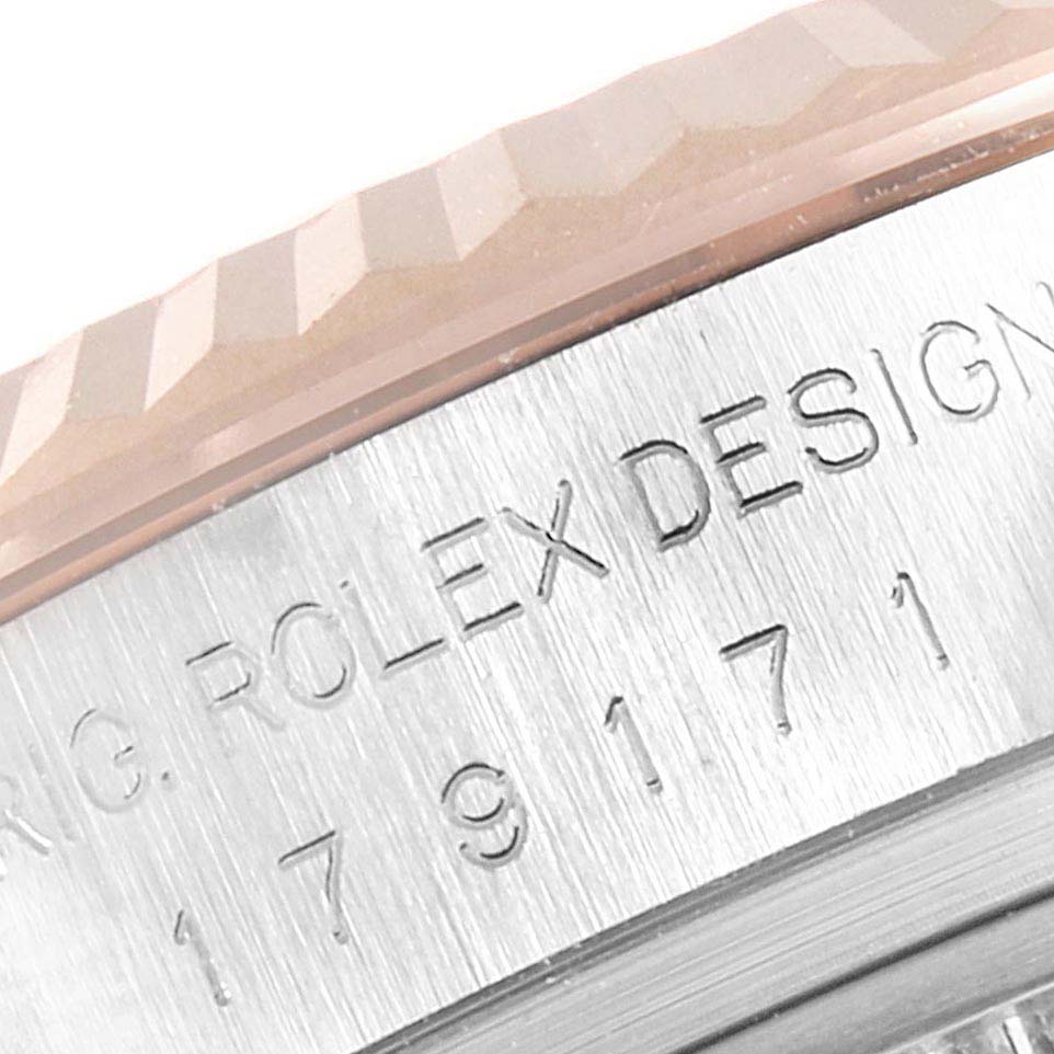 This close-up image shows the engraved bezel and part of the fluted edge on a Rolex Datejust 179171 Women's Steel and Gold (two tone) White Dial 179171 Women's Steel and Gold (two tone) White Dial watch.
