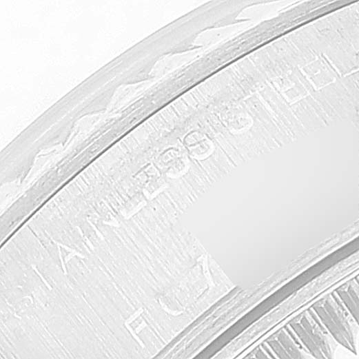 This close-up image shows a portion of the stainless steel case back on a Rolex Datejust 79174 Women's Stainless Steel Blue Dial 79174 Women's Stainless Steel Blue Dial watch.