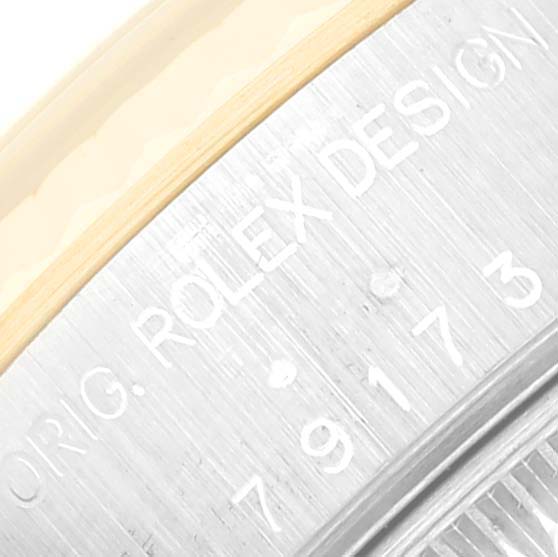 The image shows a close-up of the side of a Rolex Datejust 79173 Women's Steel and Gold (two tone) Blue Dial 79173 Women's Steel and Gold (two tone) Blue Dial watch case, highlighting the engraved "ORIG. ROLEX DESIGN" and model number.