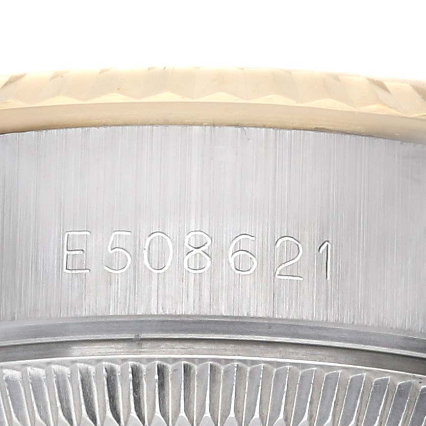 The image shows the serial number engraving on the side of the Rolex Datejust 69173 Women's Steel and Gold (two tone) Champagne Dial 69173 Women's Steel and Gold (two tone) Champagne Dial case at an angle.
