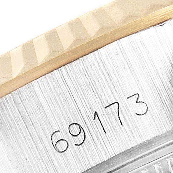 This image shows a close-up angle of the serial number and the fluted bezel on the Rolex Datejust 69173 Women's Steel and Gold (two tone) Champagne Dial 69173 Women's Steel and Gold (two tone) Champagne Dial watch.