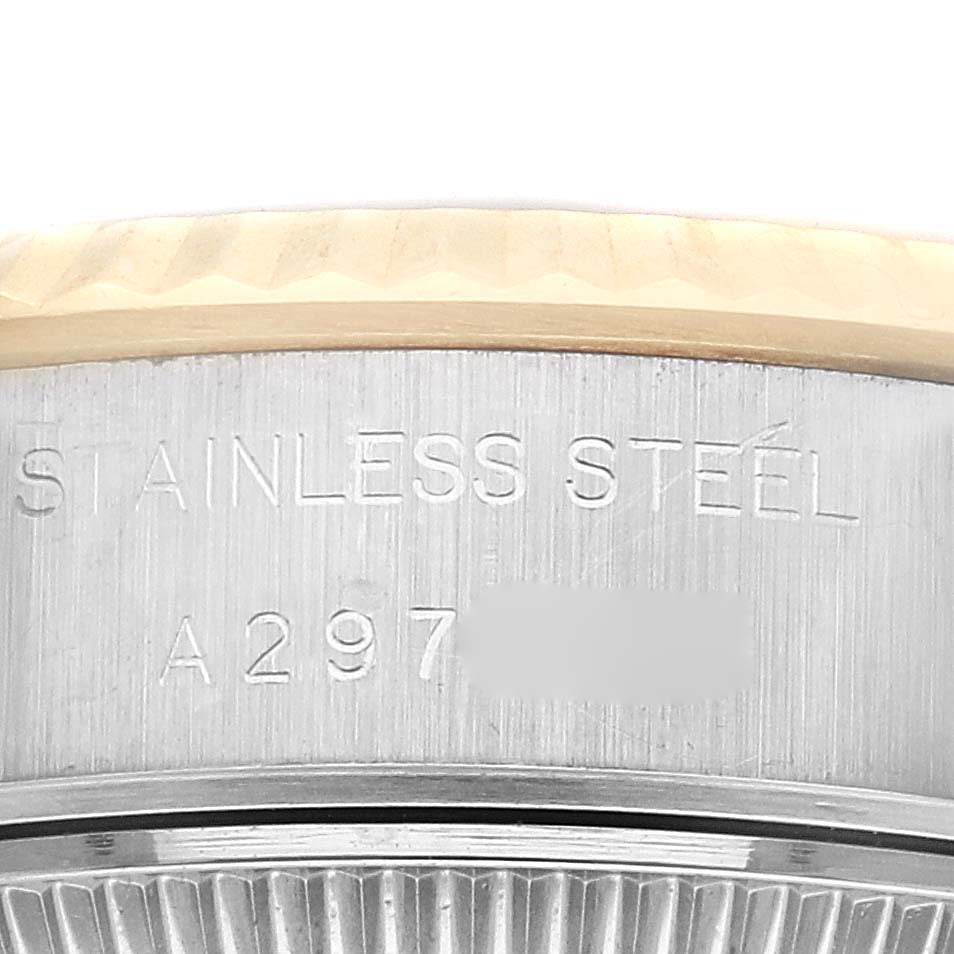 This close-up image shows the side profile and engravings on the edge of the Rolex Datejust 79173 Women's Steel and Gold (two tone) Silver Dial 79173 Women's Steel and Gold (two tone) Silver Dial watch case.