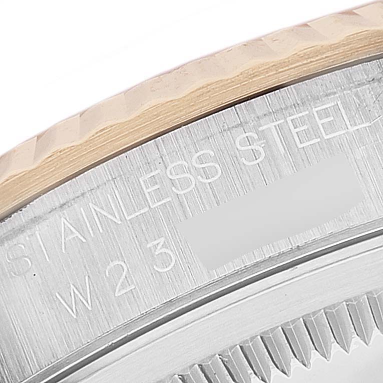 This image shows a close-up of the engraved stainless steel outer casing of a Rolex Datejust 16233 Men's Steel and Gold (two tone) White Dial 16233 Men's Steel and Gold (two tone) White Dial watch.