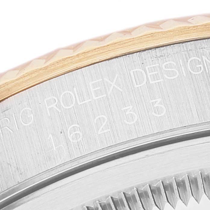 This close-up image shows part of the bezel and case back of a Rolex Datejust 16233 Men's Steel and Gold (two tone) White Dial 16233 Men's Steel and Gold (two tone) White Dial watch.
