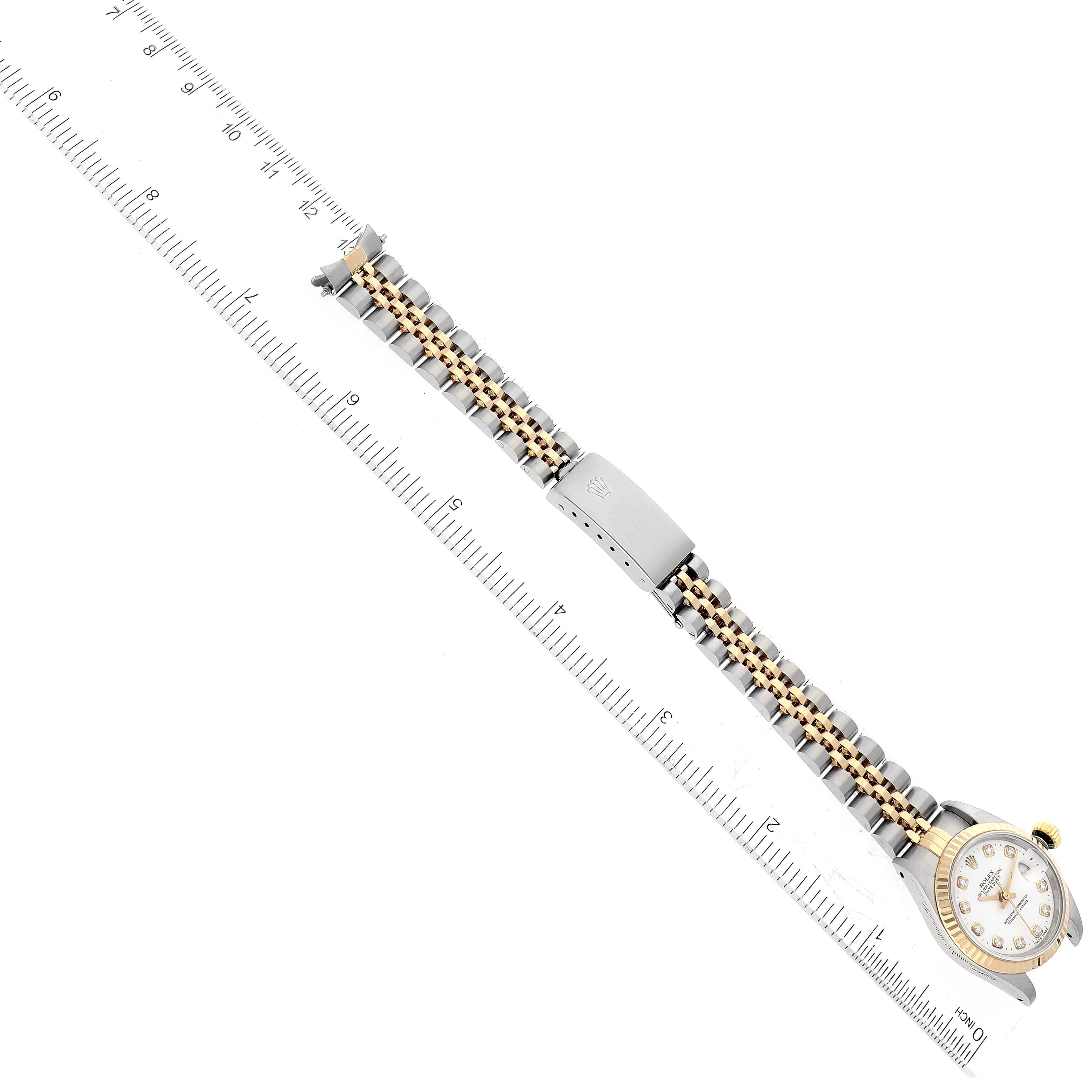 The image shows a Rolex Datejust 69173 Women's Steel and Gold (two tone) White Dial 69173 Women's Steel and Gold (two tone) White Dial watch laid flat with a ruler next to it for measurement.