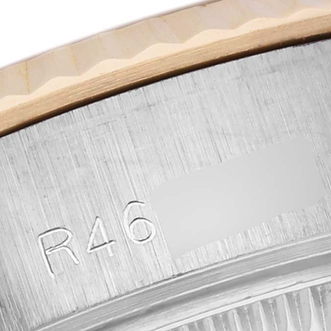 The image shows a close-up of the engraved side of a Rolex Datejust 69173 Women's Steel and Gold (two tone) White Dial 69173 Women's Steel and Gold (two tone) White Dial bezel.