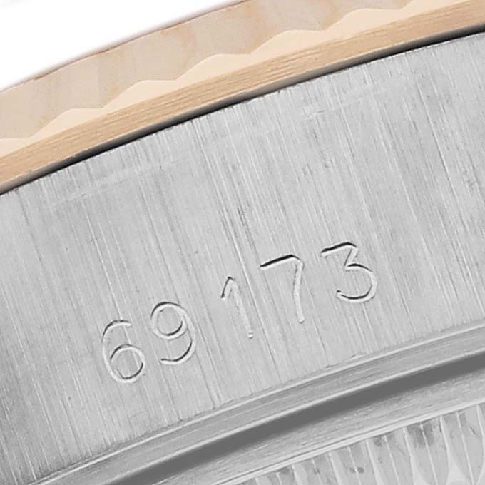 The image shows a close-up of the Rolex Datejust 69173 Women's Steel and Gold (two tone) White Dial 69173 Women's Steel and Gold (two tone) White Dial model's serial number engraving on its case side.