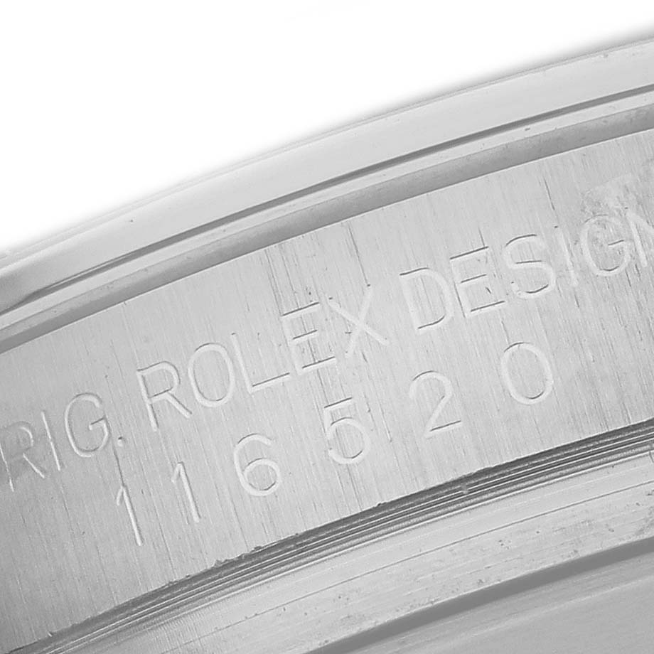 The image shows the engraved side of the bezel of a Rolex Daytona 116520 Men's Stainless Steel White Dial 116520 Men's Stainless Steel White Dial watch, focusing on the model number and branding.