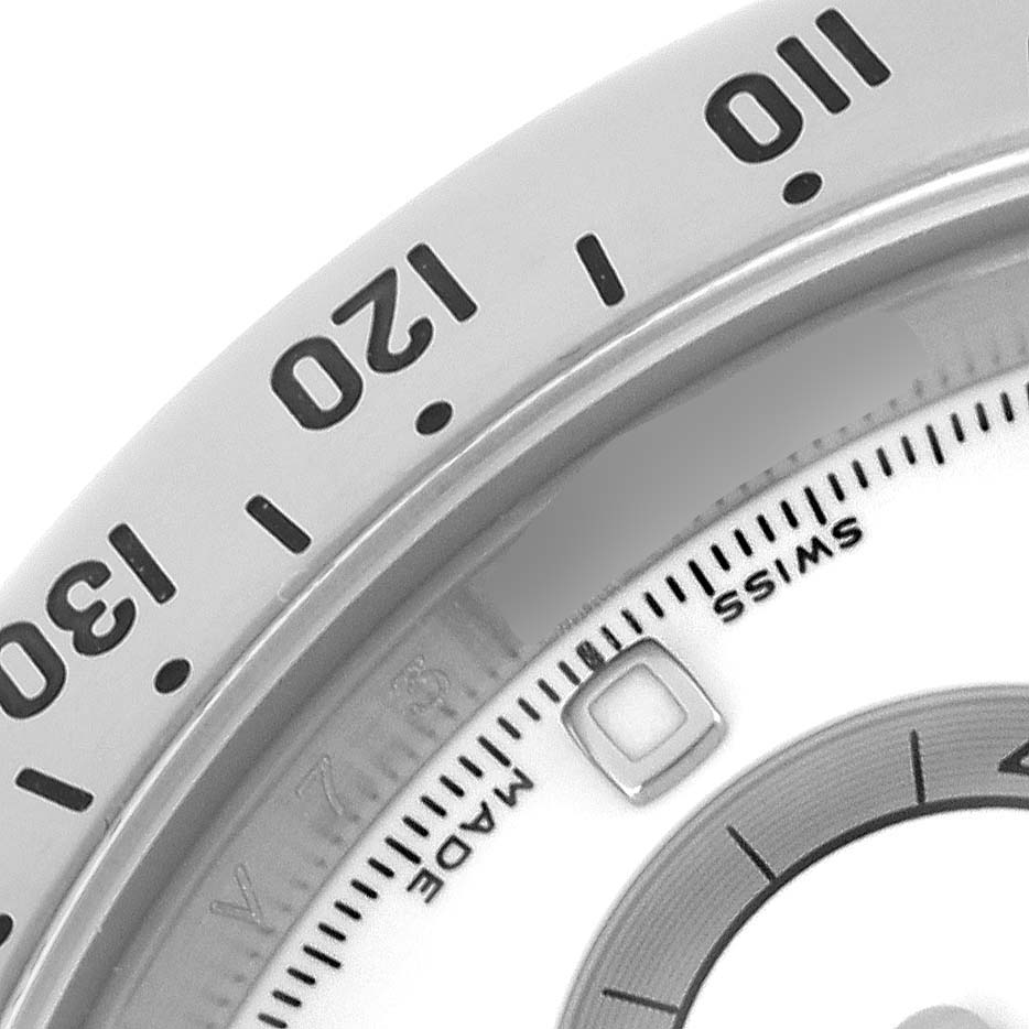 The image shows a close-up of the bezel and part of the dial on a Rolex Daytona 116520 Men's Stainless Steel White Dial 116520 Men's Stainless Steel White Dial watch.